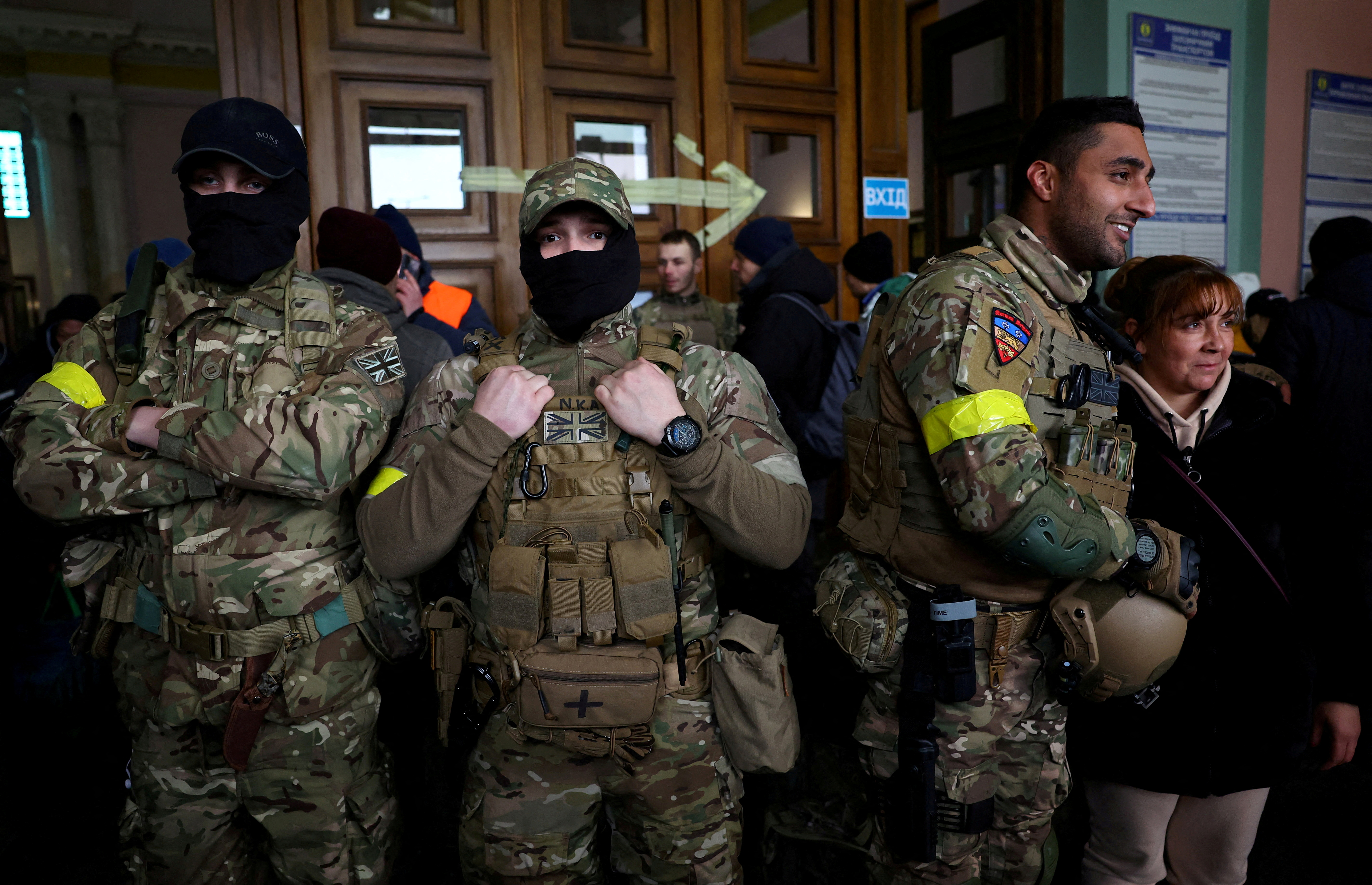 Ben Grant and other foreign fighters from the UK pose for a picture as they are ready to depart towards the front line in the east of Ukraine