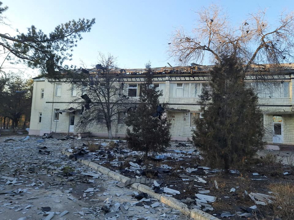 A bombed out hospital in Sievierodonetsk with rubble strewn on the ground in front,