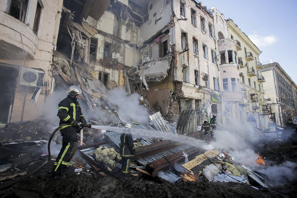 Firefighters extinguish an apartment house after a Russian rocket attack in Kharkiv.