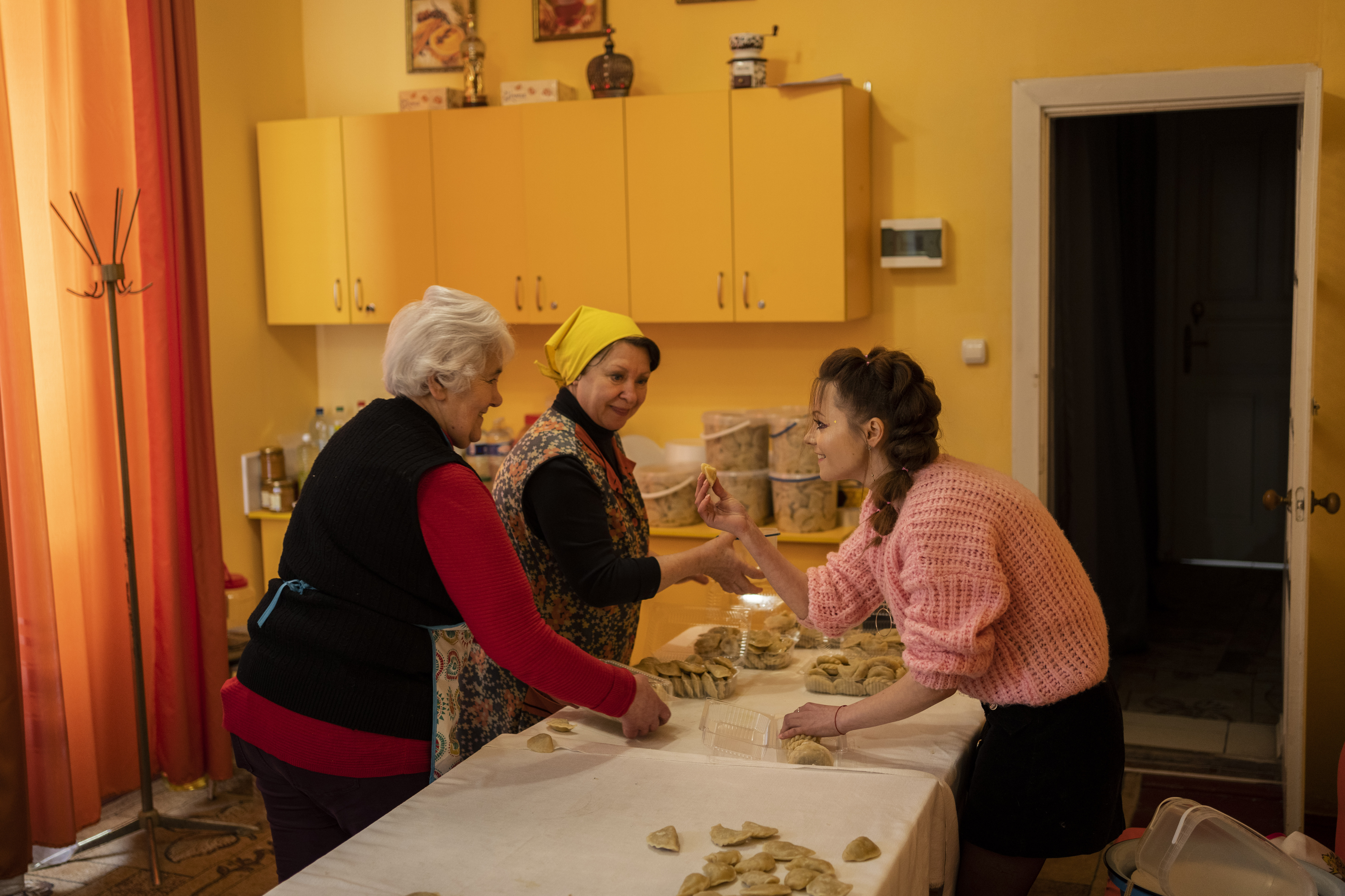 Volunteers prepare varenyky, stuffed dumplings, inside a theatre in the city of Drohobych