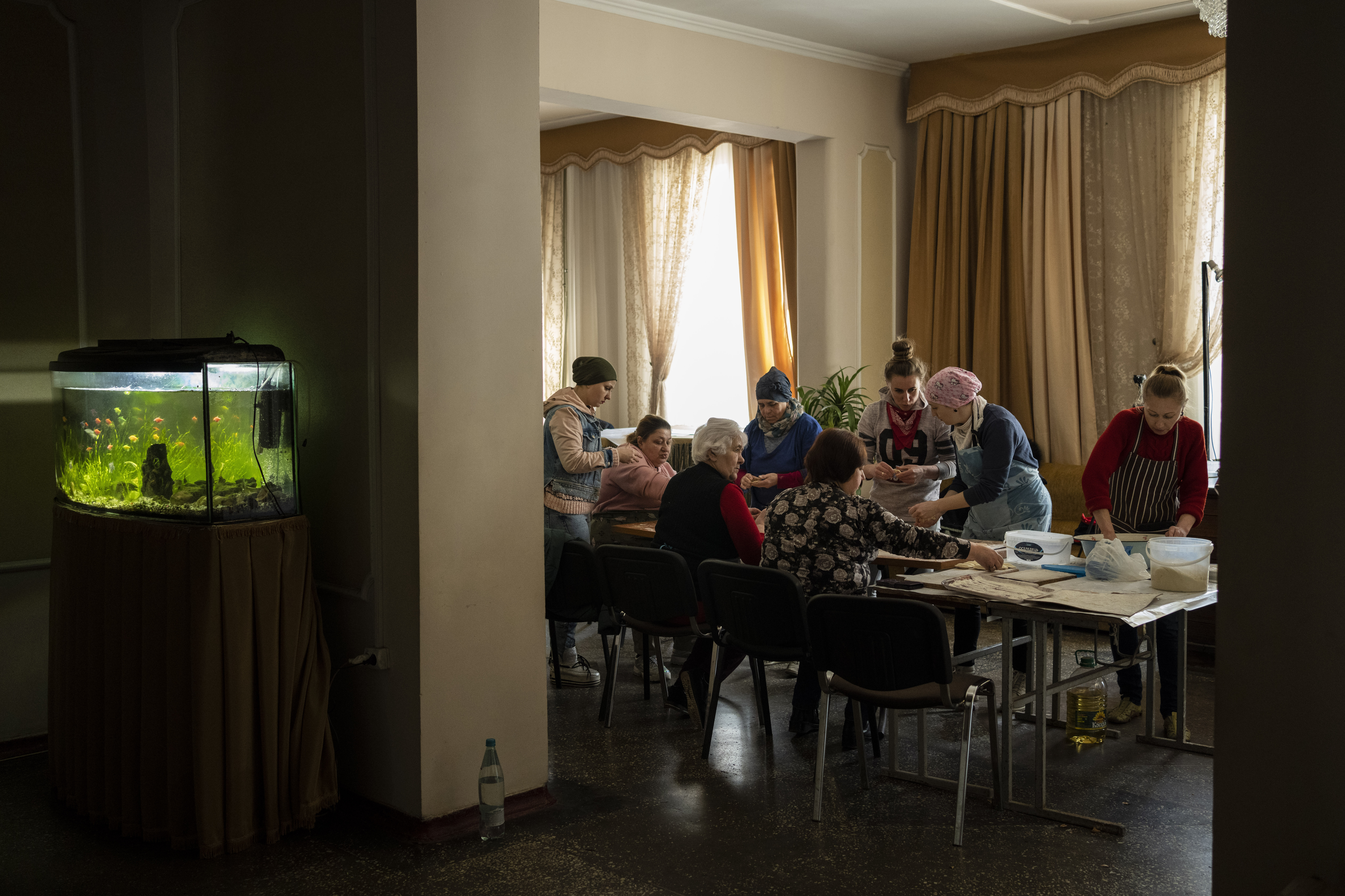 Volunteers prepare varenyky, stuffed dumplings