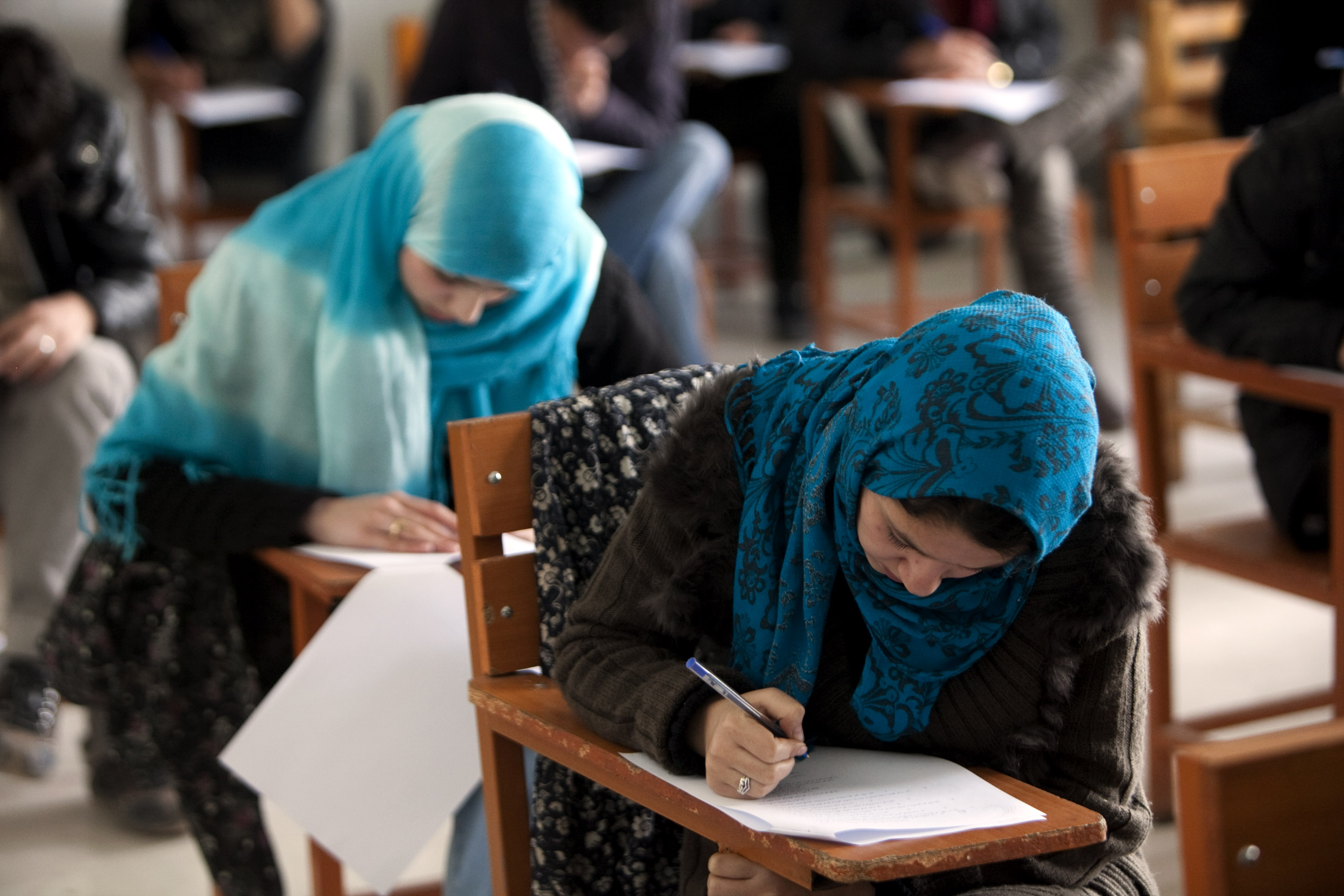 Afghan students seen as they write an exam