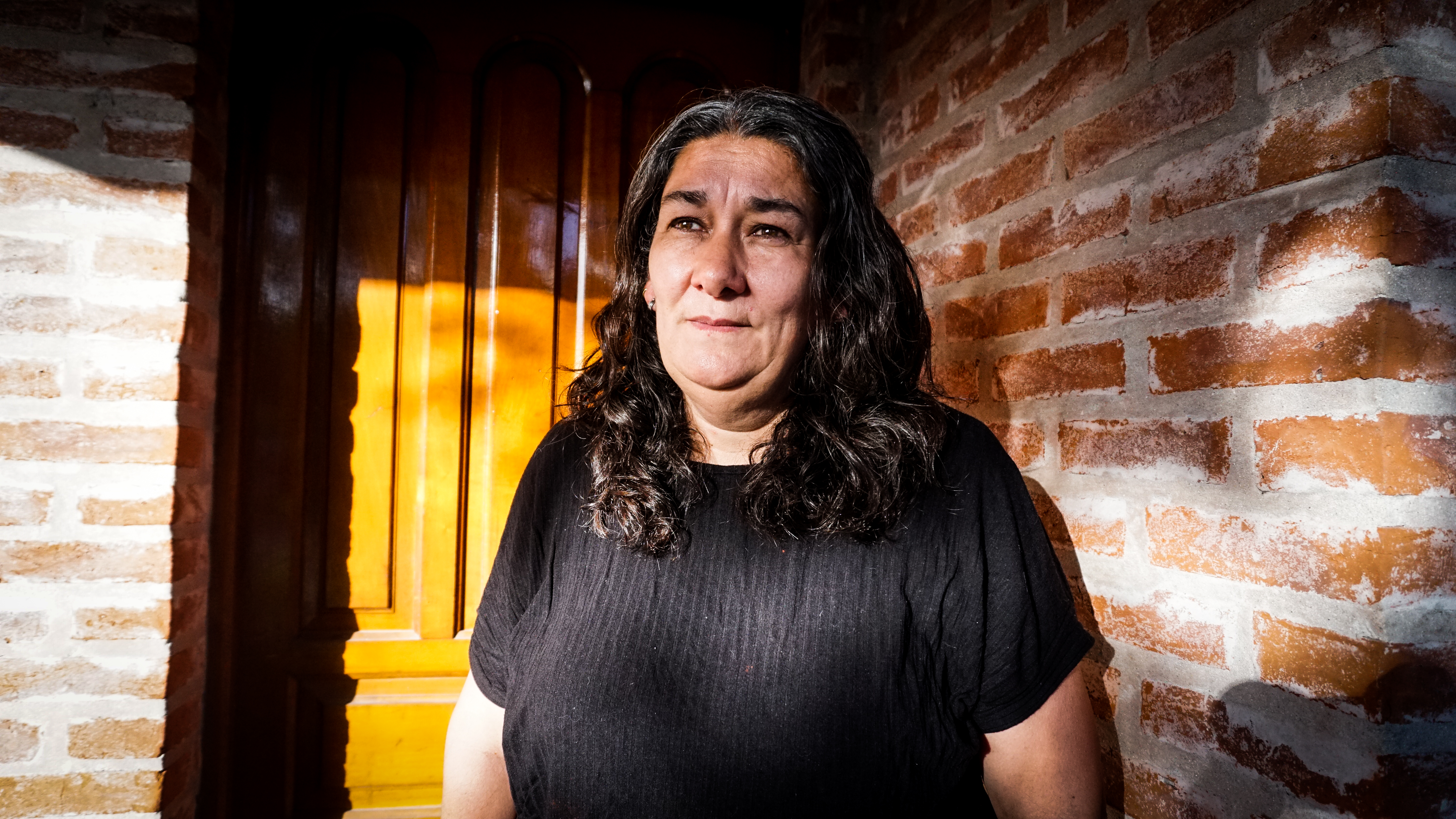 Marta Montero stands outside her home in Mar del Plata, Argentina