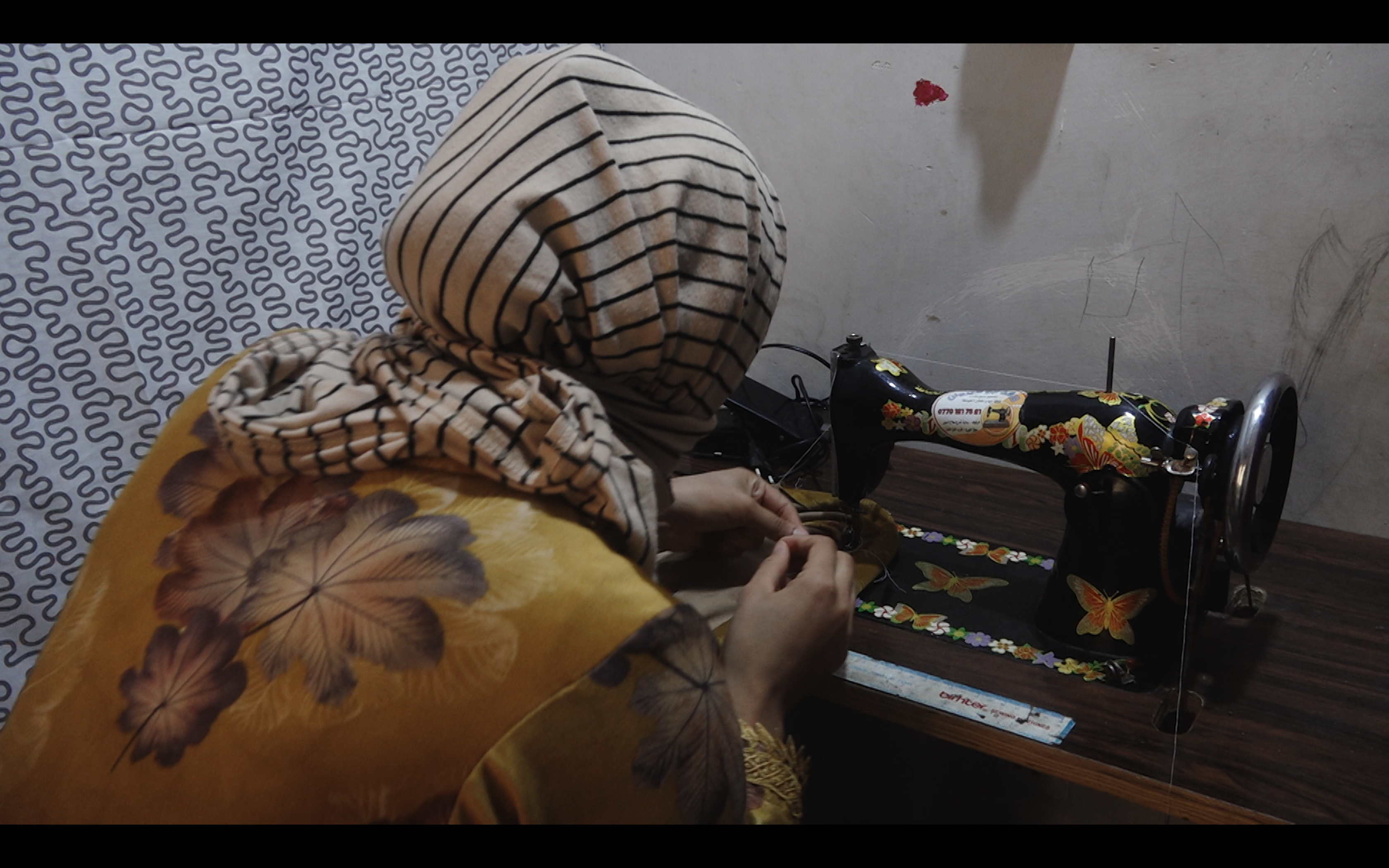 A woman works at a sewing machine