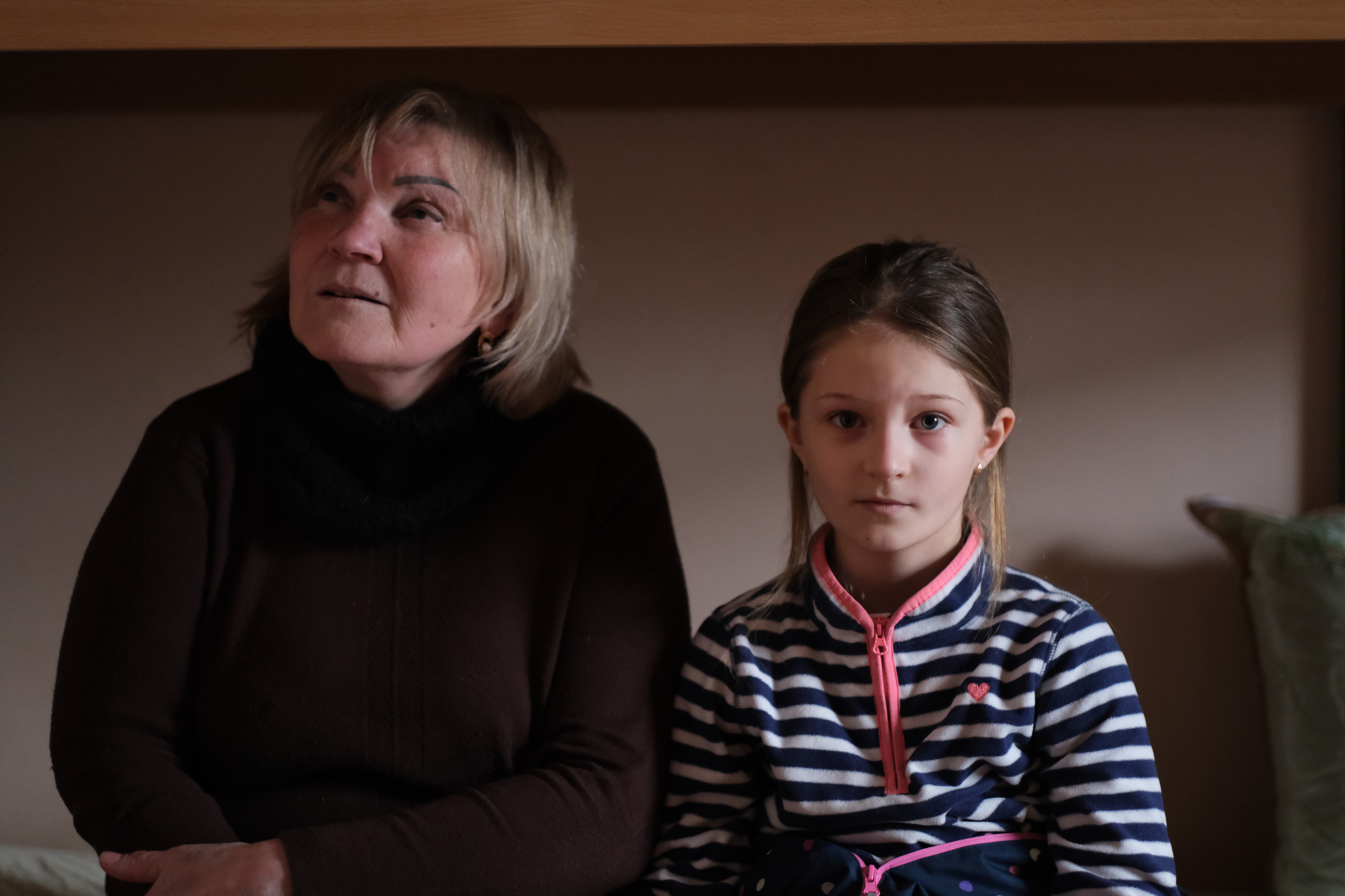 A photo of a woman and a child next to her.