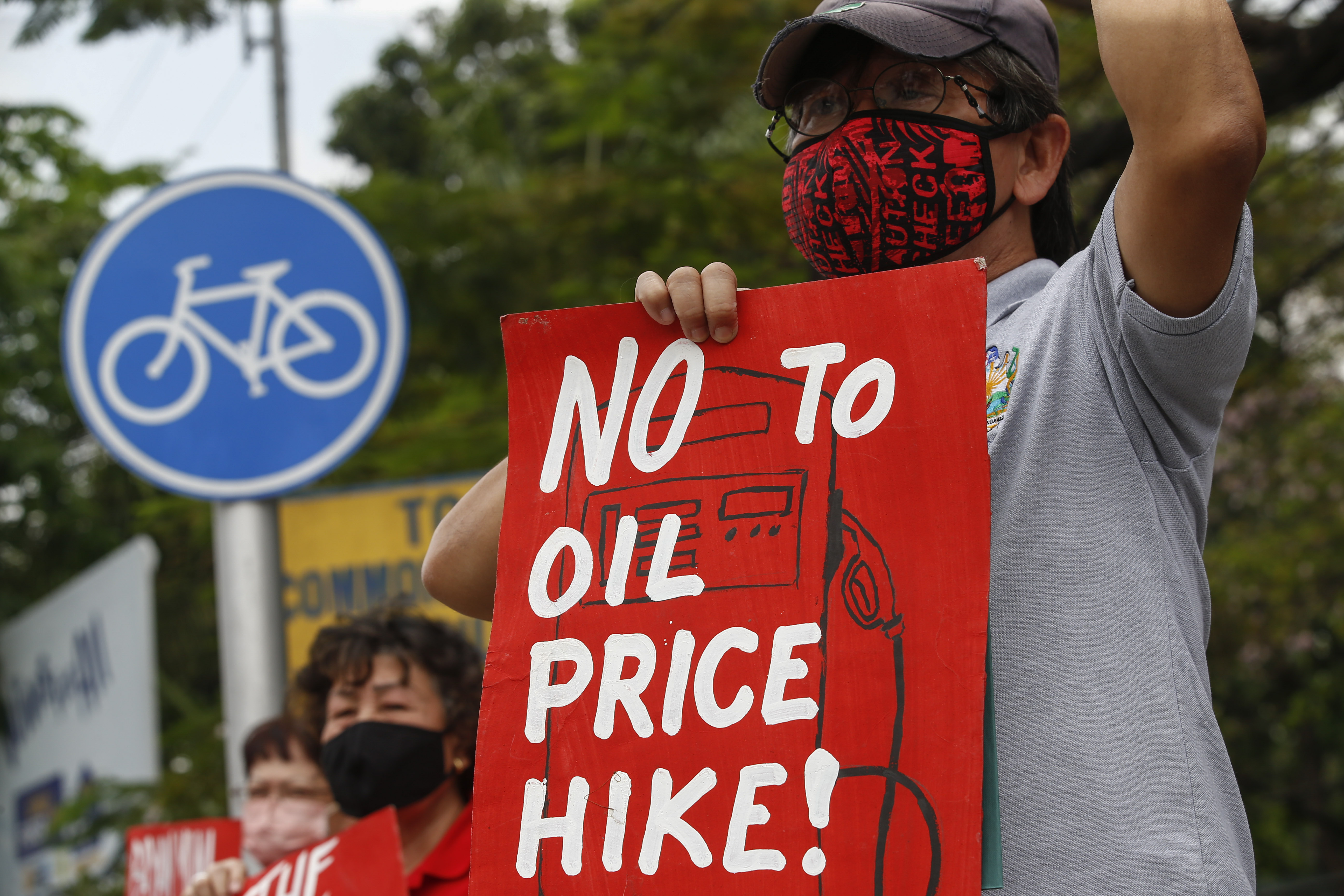 A protester holds a sign during a rally against fuel price hikes in Quezon City, Philippines