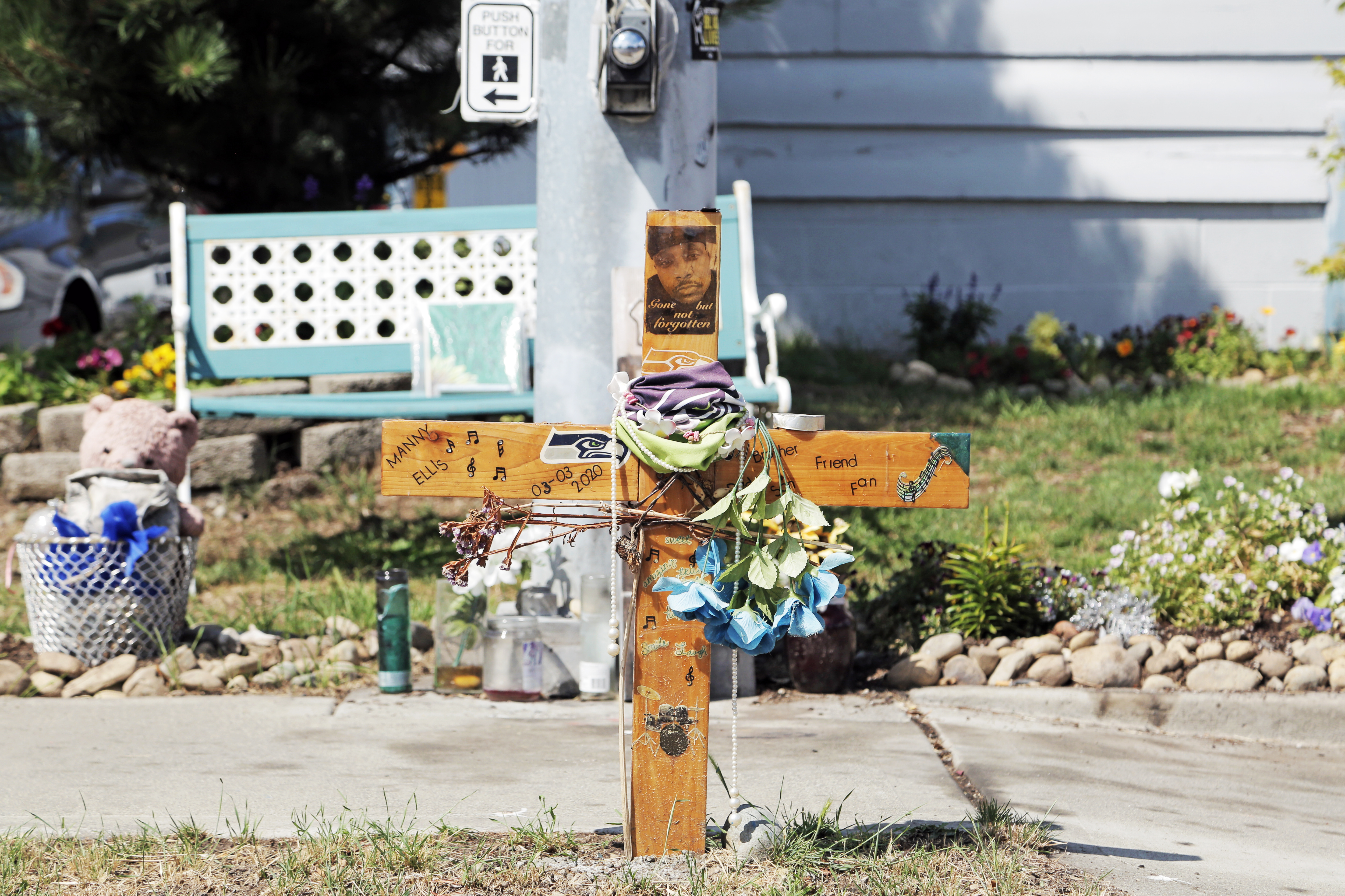 A small wooden cross marks the spot on small patch of grass where Manuel Ellis was killed