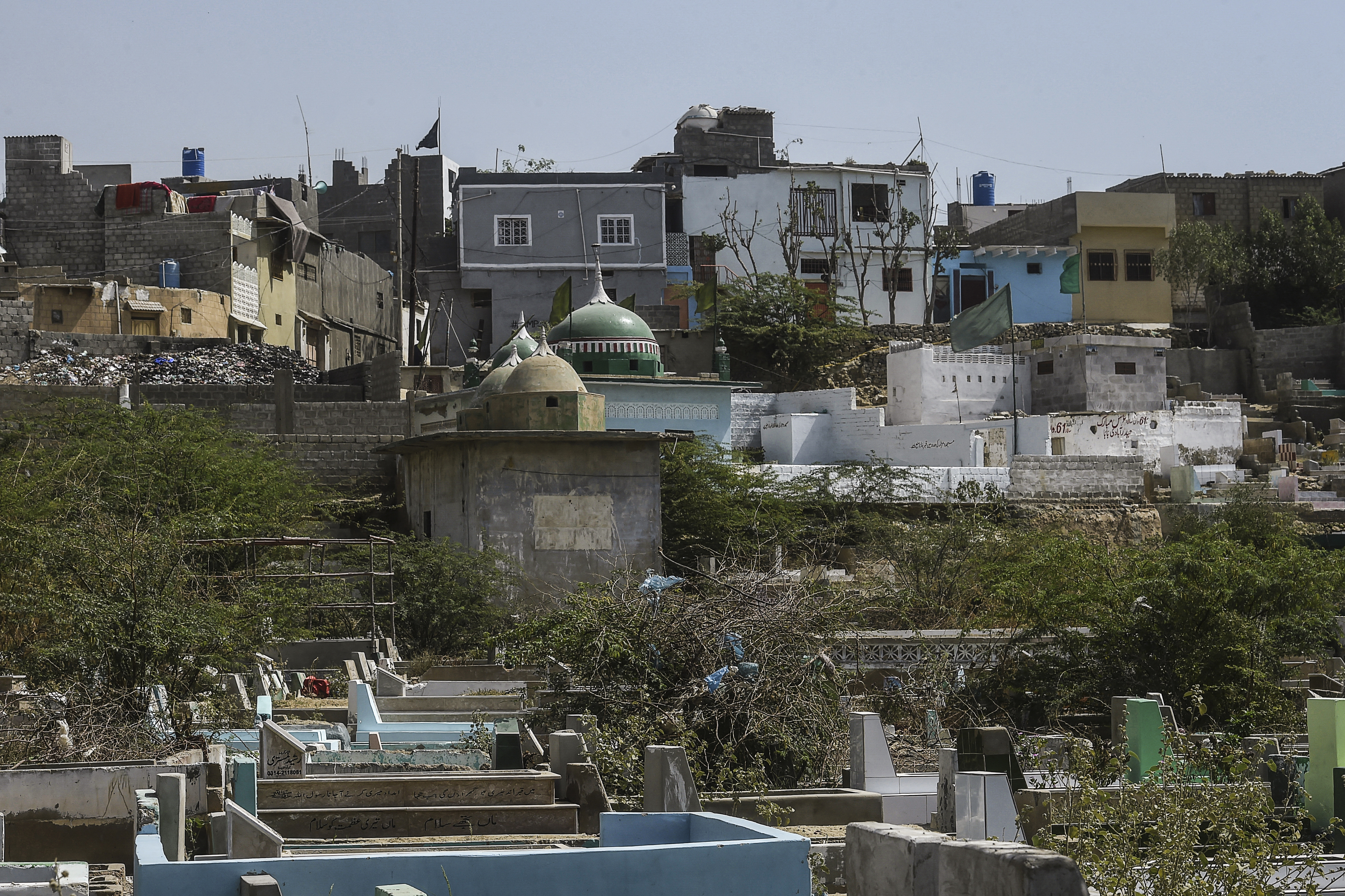 residential buildings (top) beside the Korangi graveyard