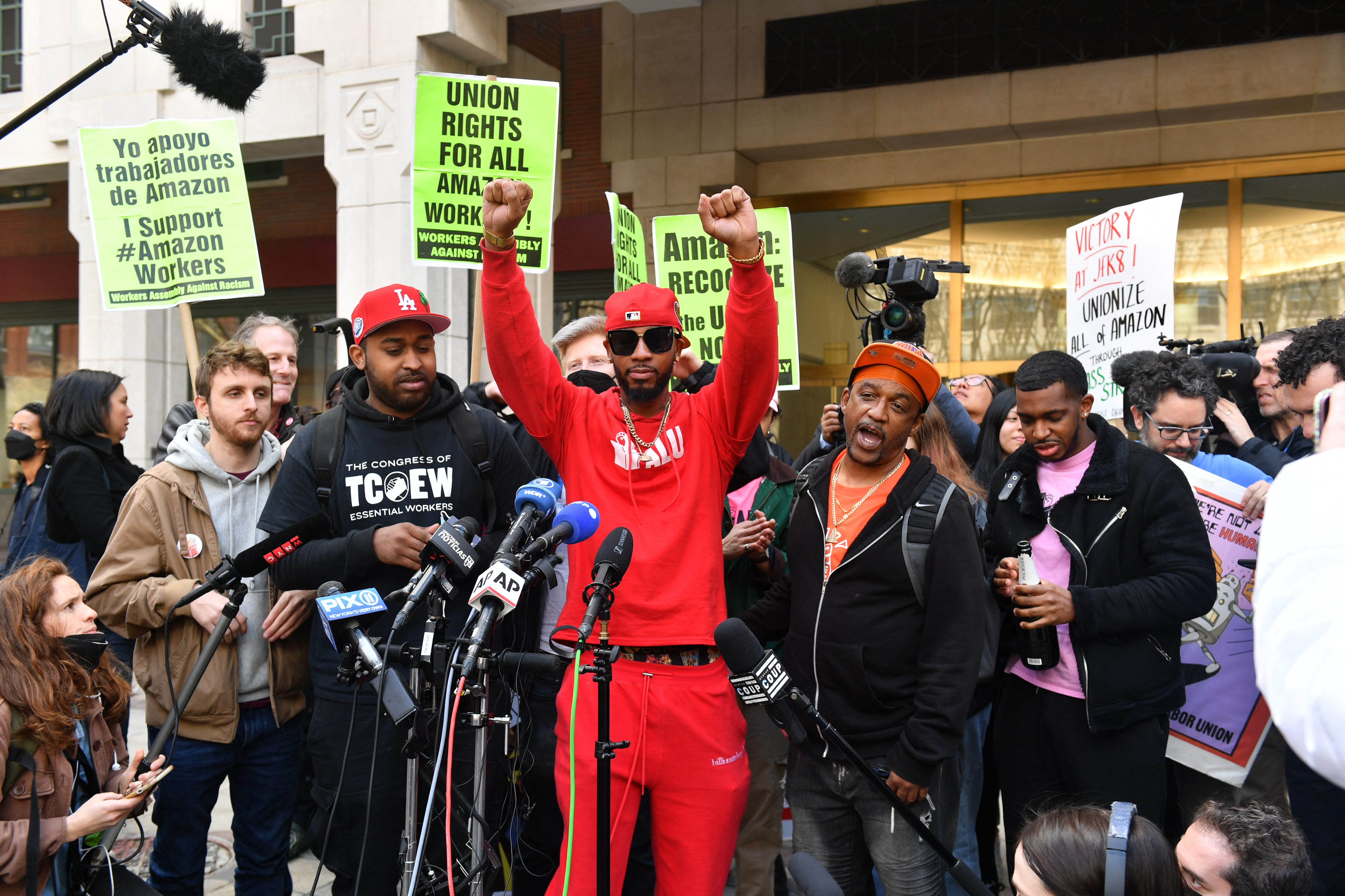 Union organizer Christian Smalls (C) celebrates as he speaks following the vote for the unionization of the Amazon Staten Island warehouse in New York.