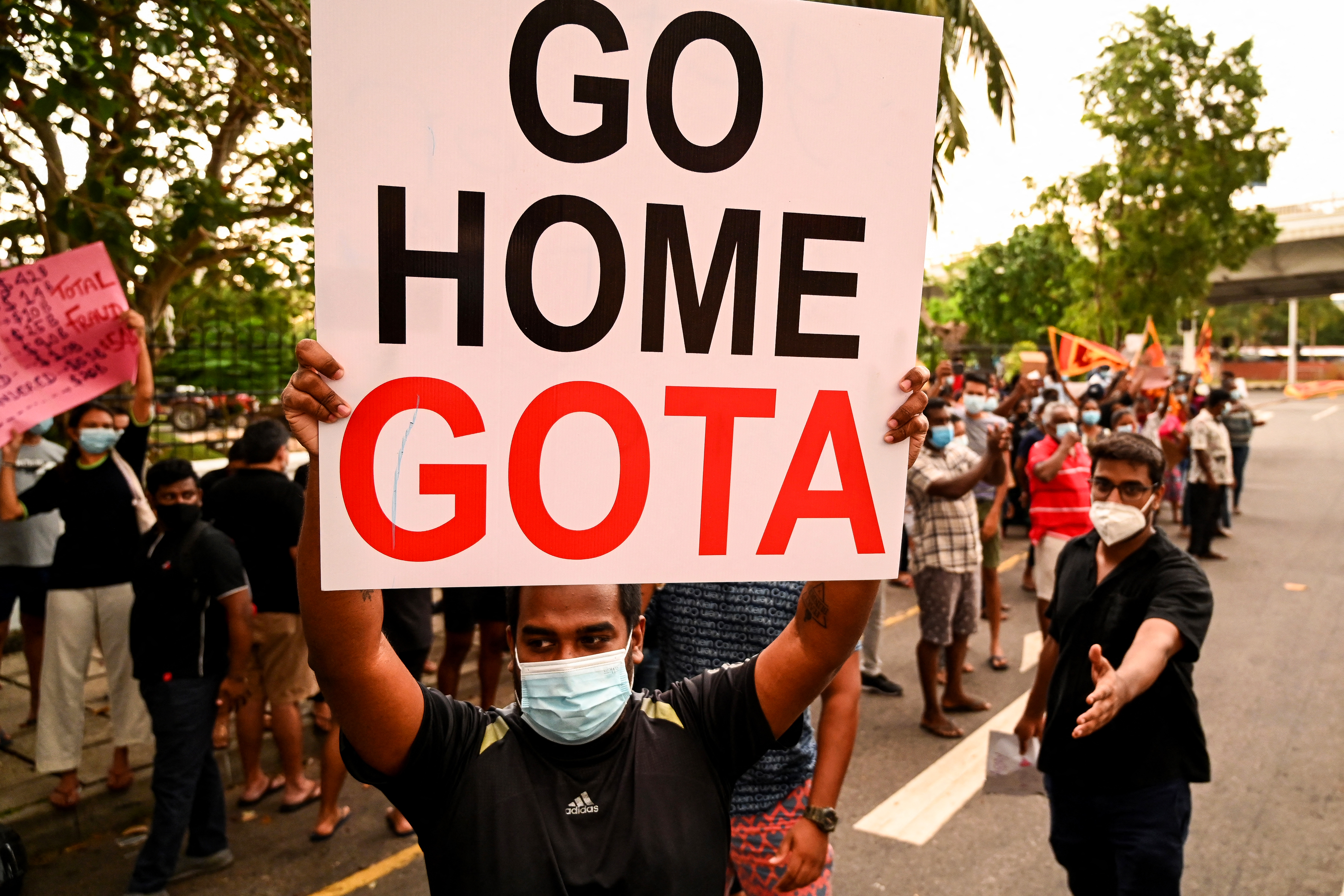 Protestors hold banners and placards during a demonstration against the surge in prices and shortage of fuel and other essential commodities in Colombo