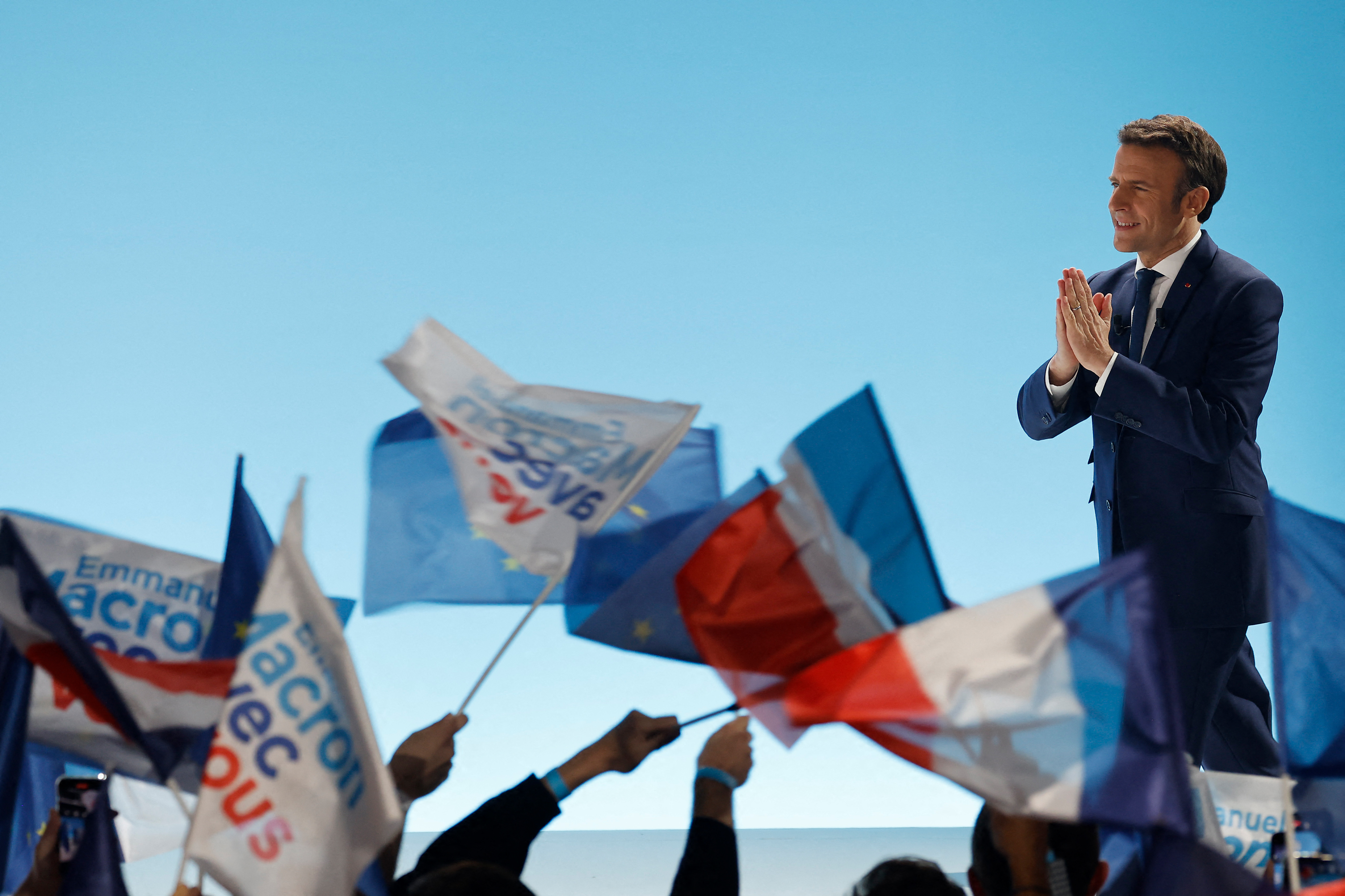 Macron is seen on stage after the results of first round of 2022 presidential elections