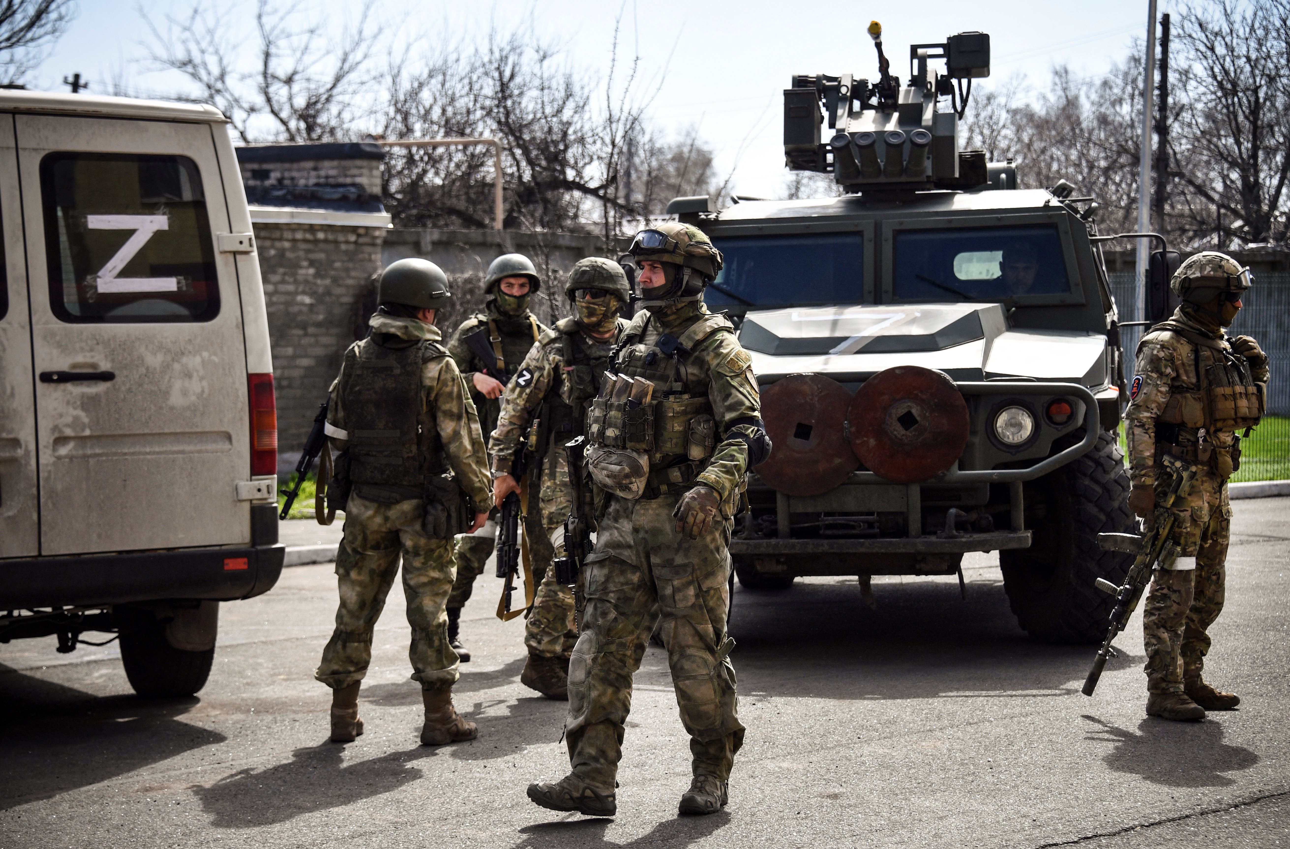 Russian soldiers are seen patrolling a street in Volnovakha, eastern Ukraine.