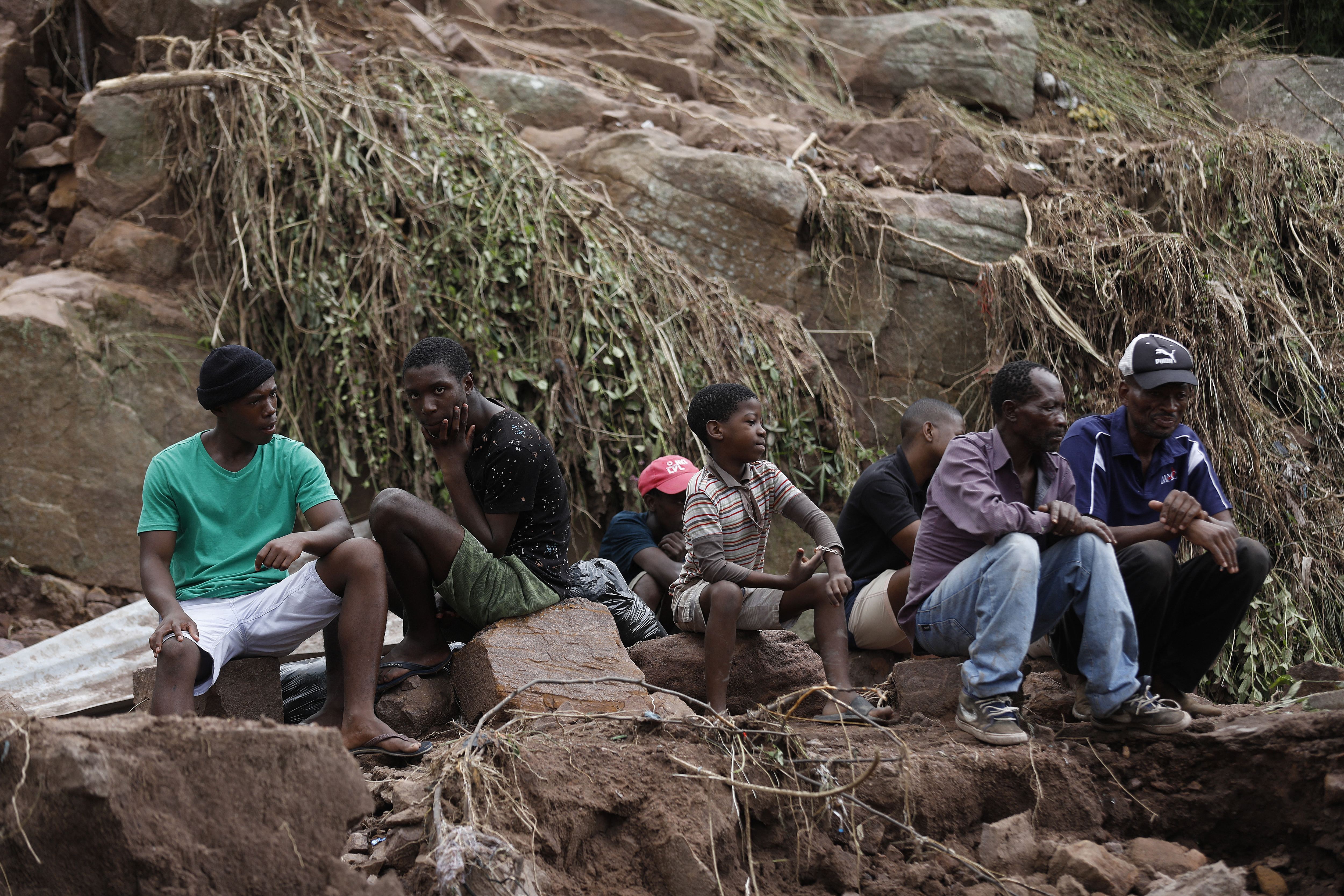 Neighbours watch as members South African Police Services (SAPS) Search and Rescue Unit use sniffer dogs to locate missing people 