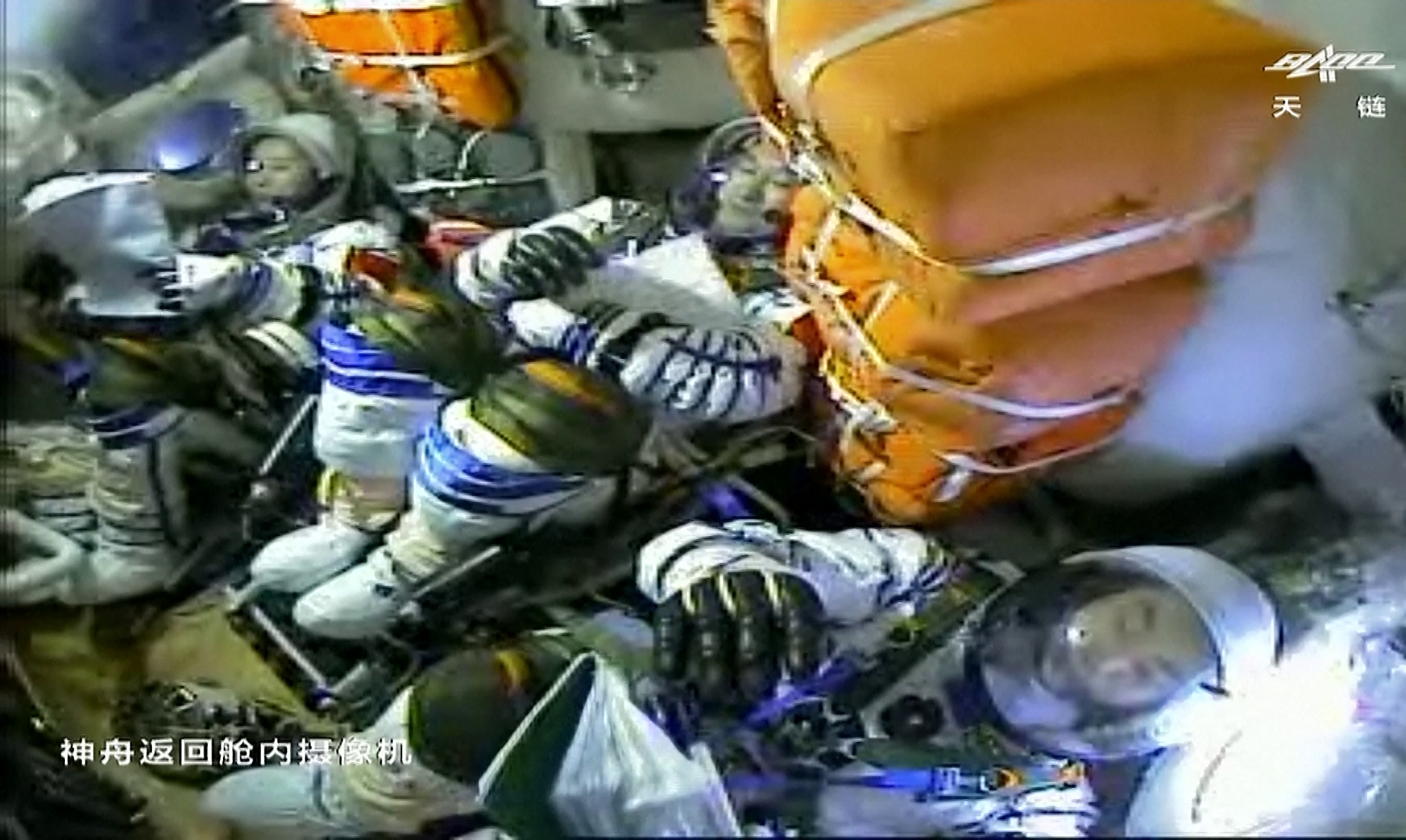 The three Chiense astronauts inside the capsule before their return to Earth