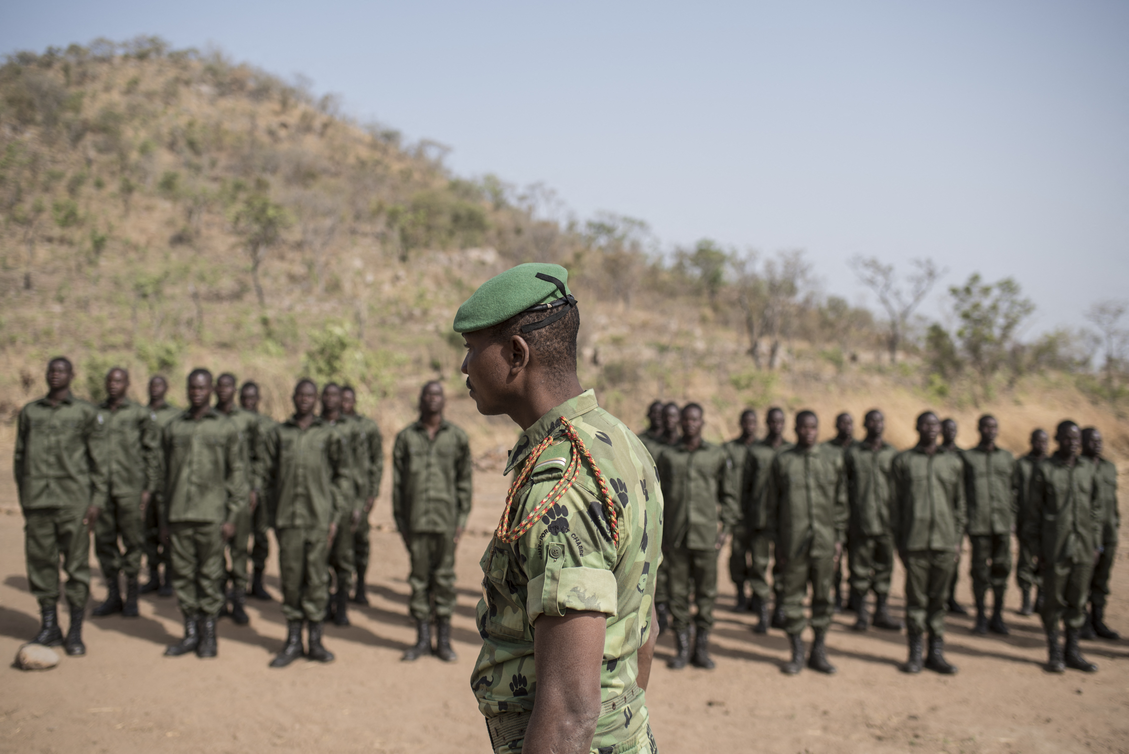 Rangers stand on attention on the parade ground during a graduation ceremony on January 12, 2018 at the Pendjari National Park training facility near Tanguieta