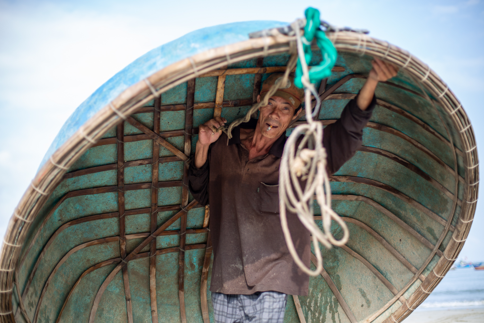 A photo of a whale worshipper carrying his coracle.