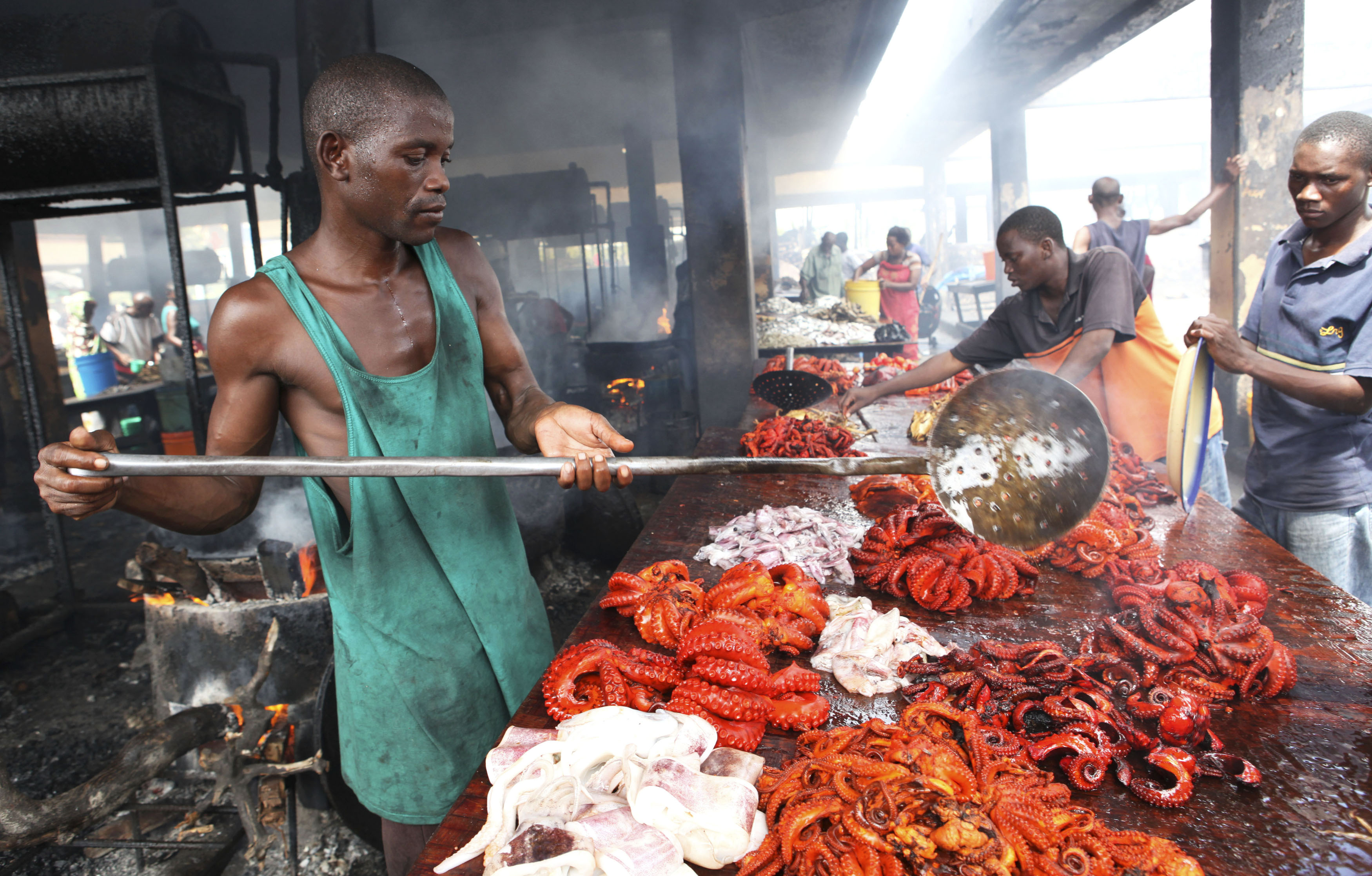 Tanzanian traders deep-fry freshly caught octopus in order to keep them from turning bad at a market near the shores of the commercial capital Dar es Salaam