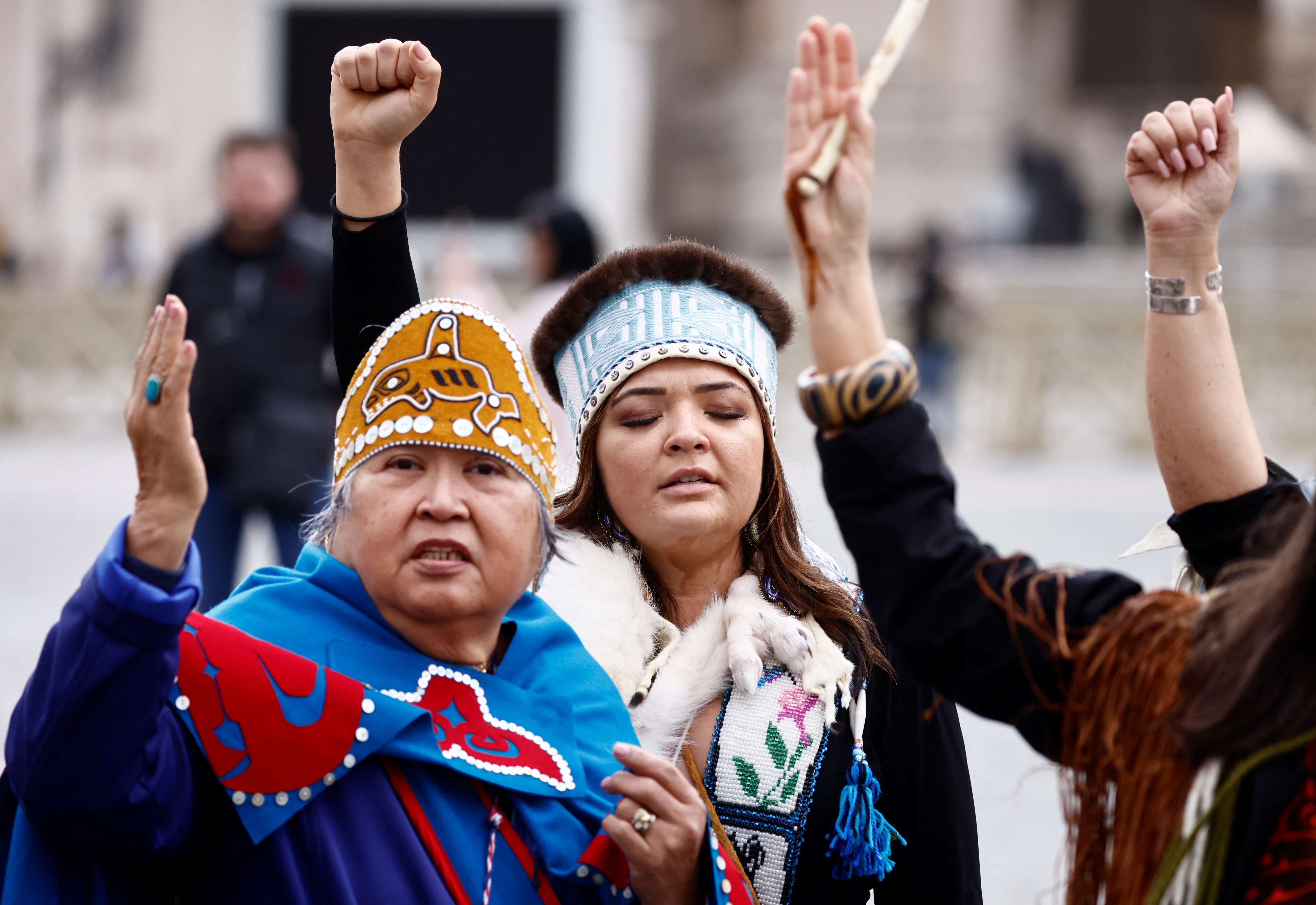 First Nations women gesture in Rome after the pope's apology for residential school abuses