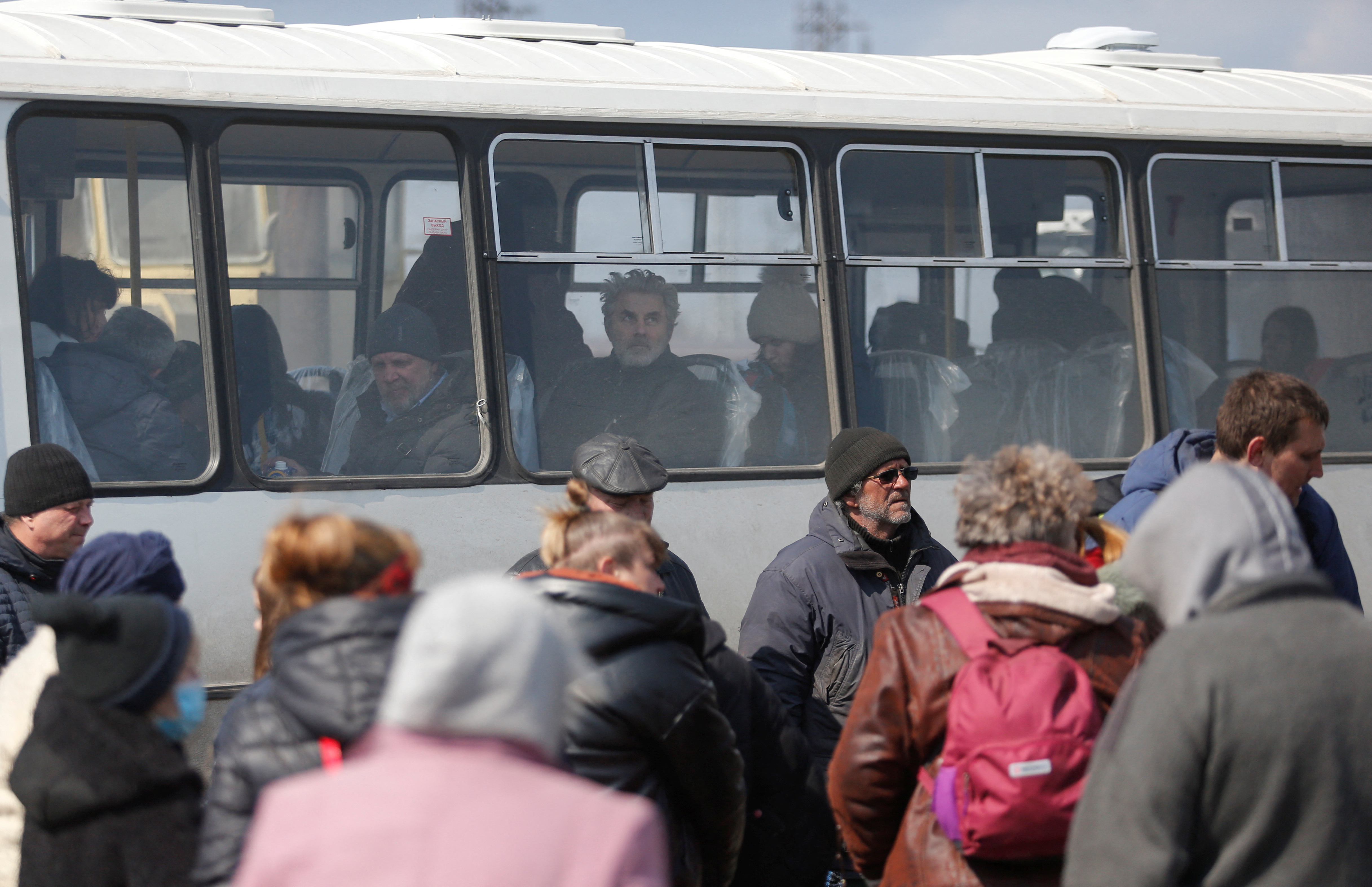 Evacuees are seen on a bus as they leave Mariupol