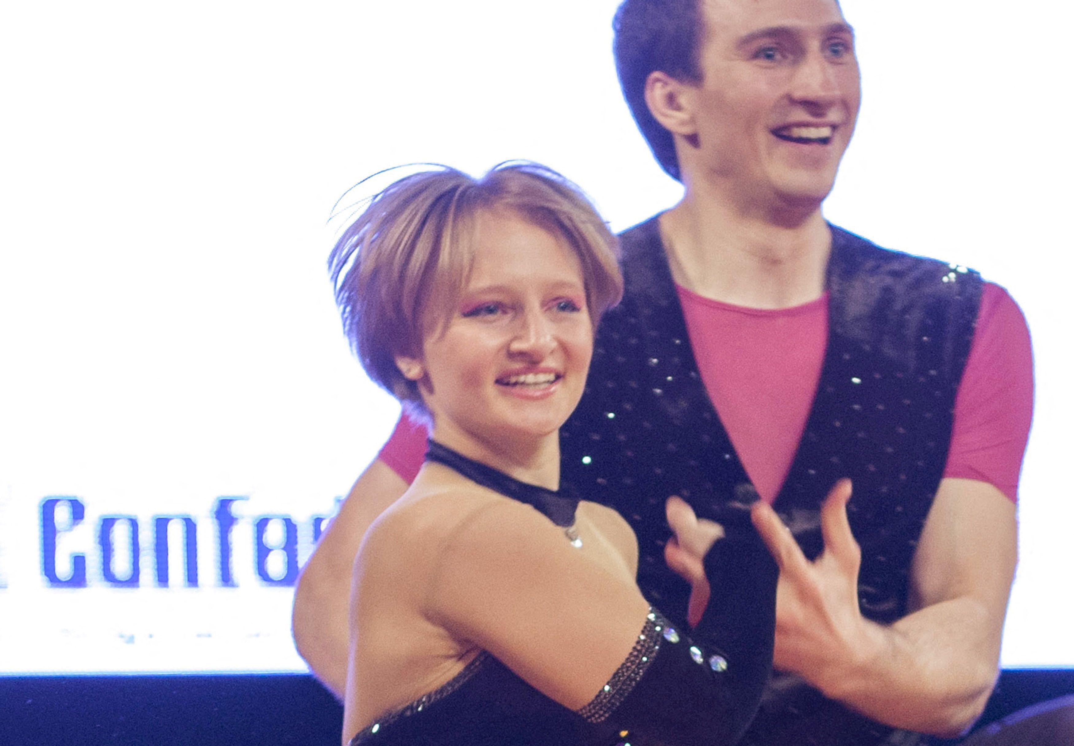 Katerina Tikhonova with short blonde hair and wearing a black sparkly leotard, daughter of Russian President Vladimir Putin, dances with a partner during the World Cup Rock'n'Roll Acrobatic Competition in Krakow, Poland, in April 2014.