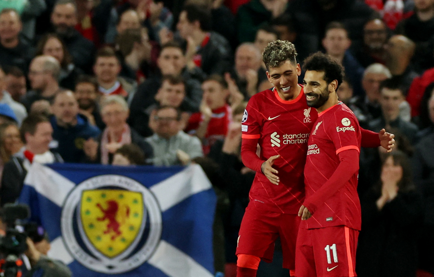 Roberto Firmino celebrates scoring their third goal with Mohamed Salah