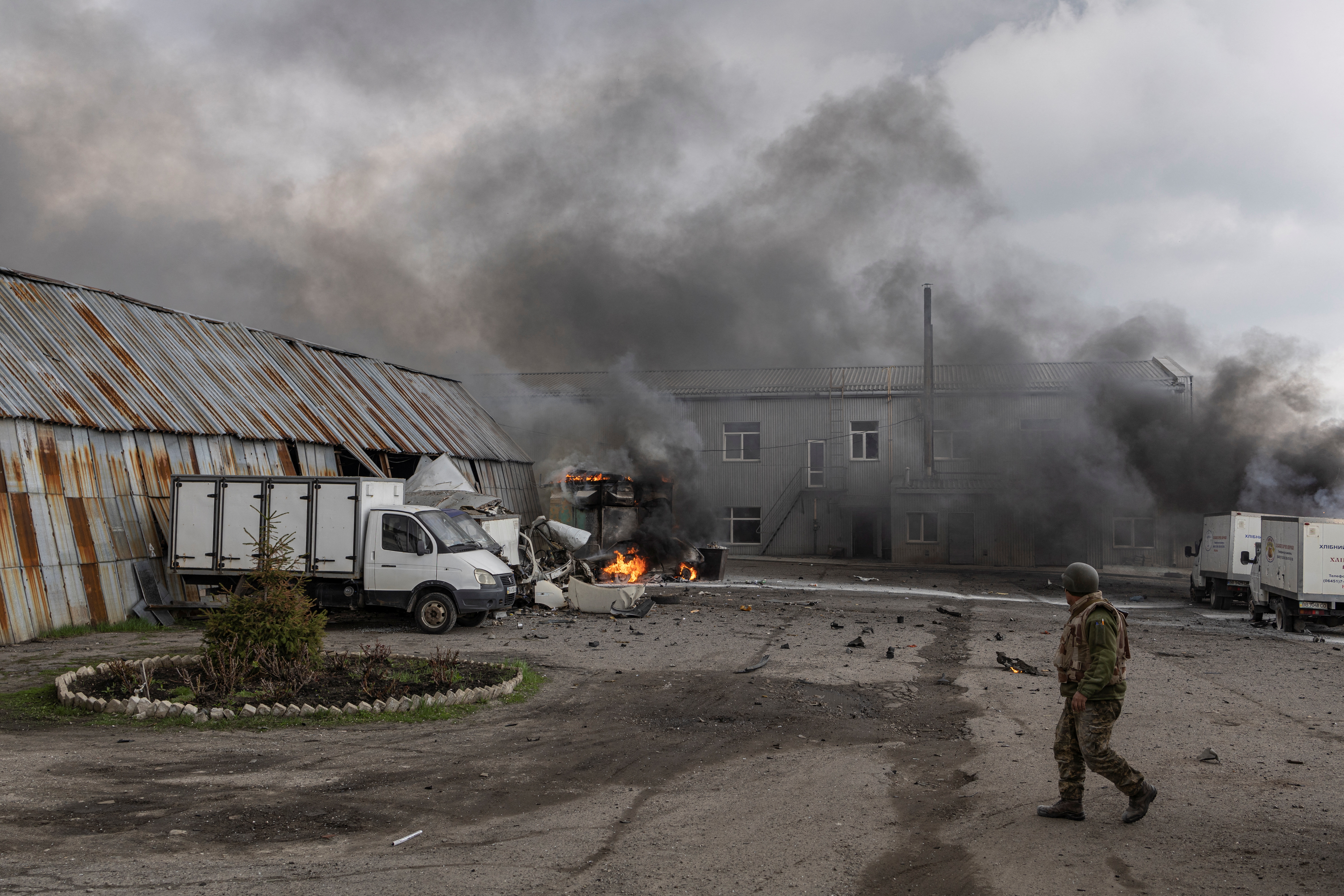 A Ukrainian soldier stands in front of a building after it was hit by shelling in Lysychansk, Luhansk region, Ukraine, 