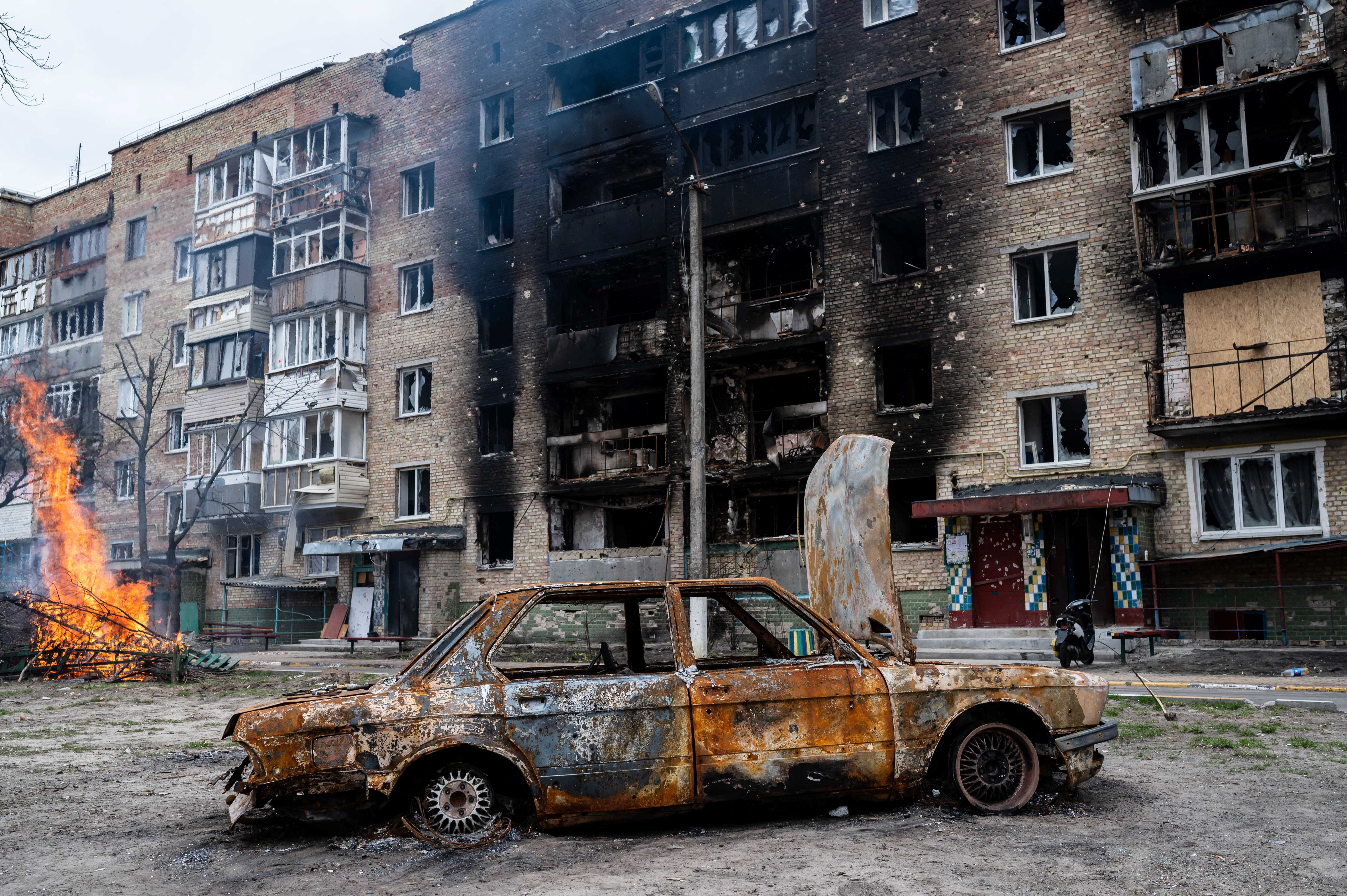 A destroyed car and building in Irpin, near Kyiv