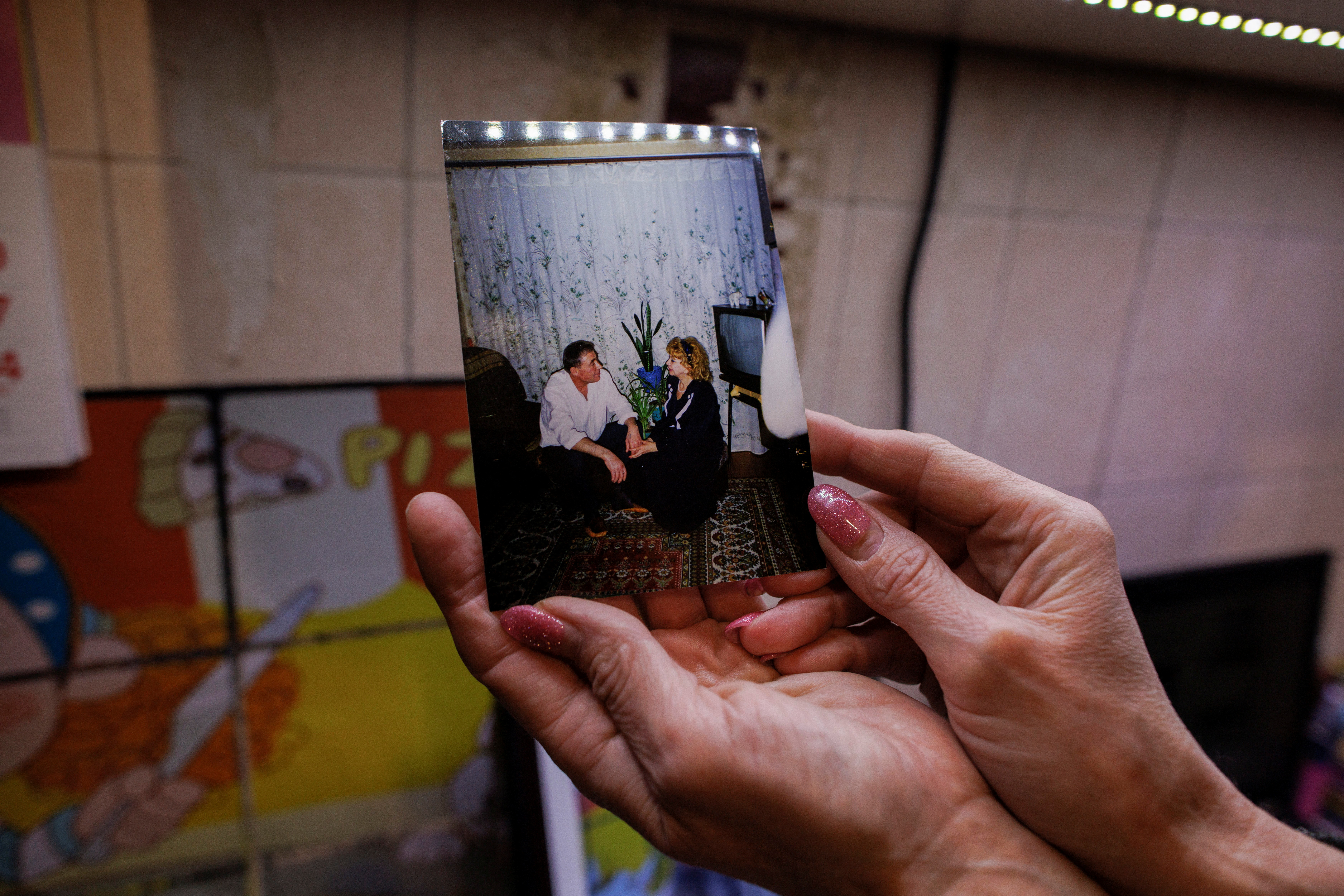 Yana Bachek holds a photo of her mother Luybov Gubareva