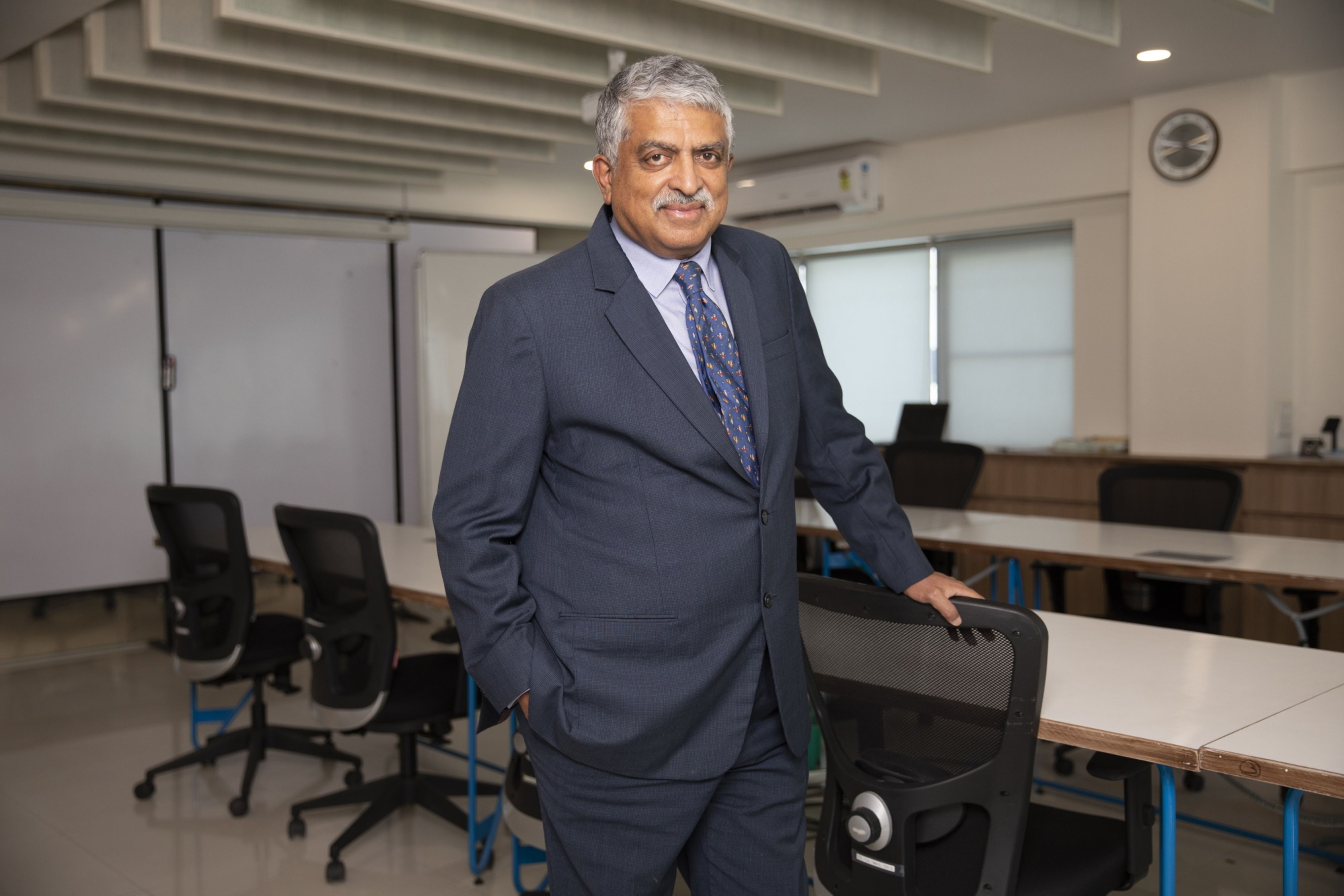 Tech mogul Nandan Nilekani posing in a boardroom