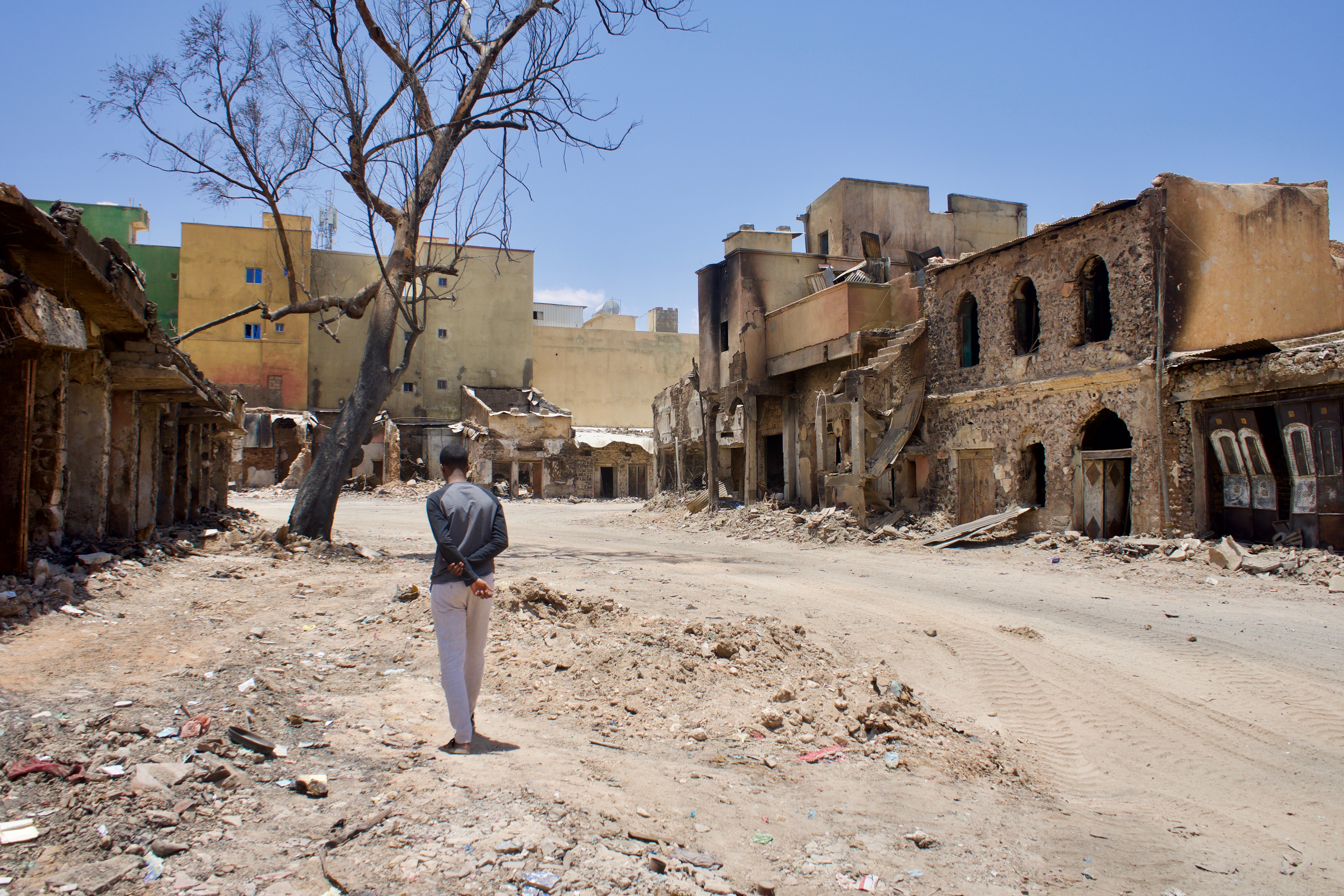 A man walks through the fire site at Waheen market, Somaliland
