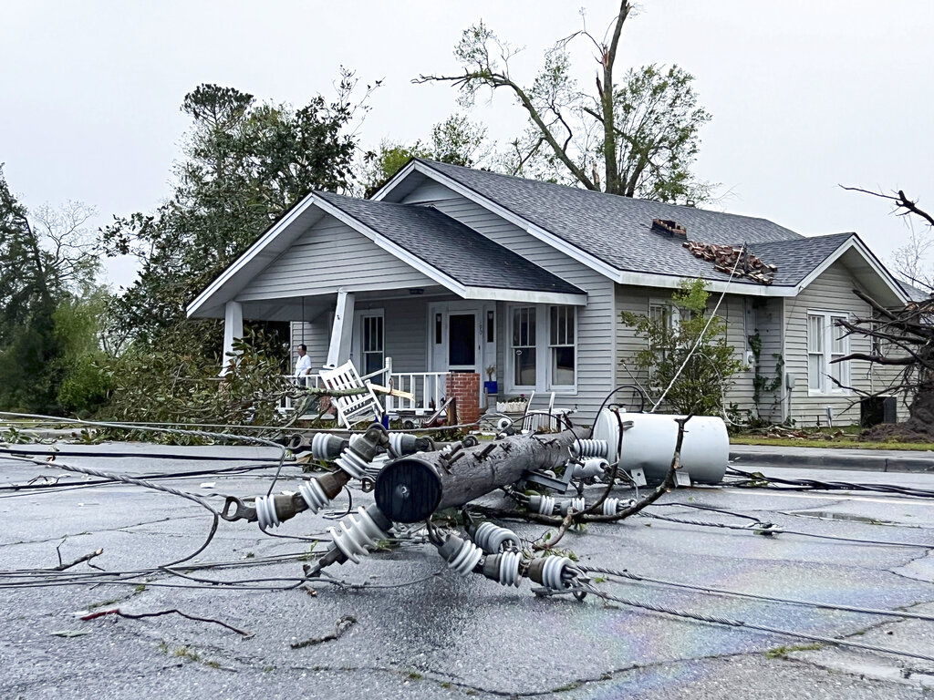 A power pole ripped from its location lies on East College street in Pembroke, Ga., after a storm damaged several homes and the Bryan County Courthouse, Tuesday, April 5, 2022. Pembroke is 30 miles from Savannah, Georgia.