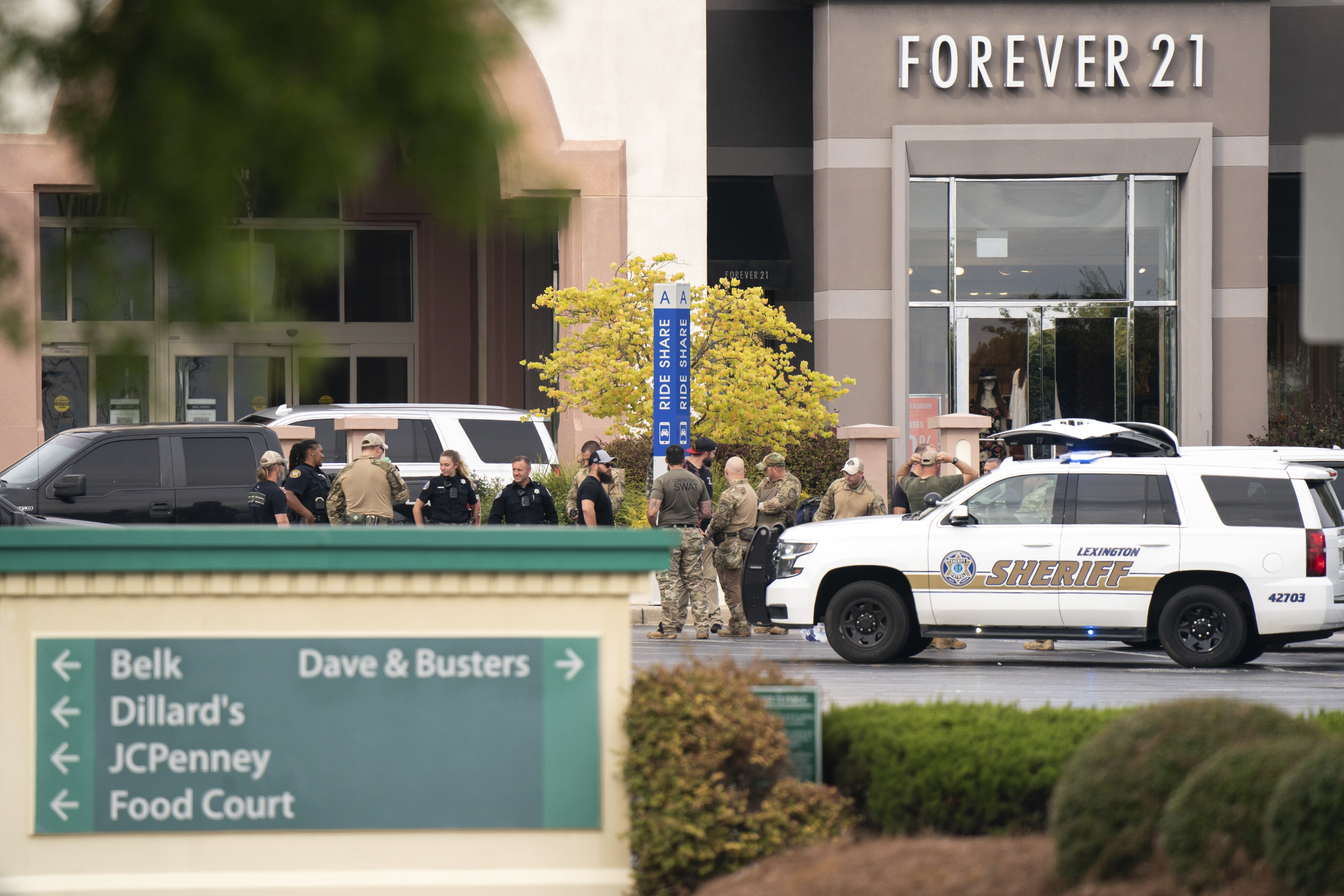 Members of law enforcement gather outside Columbiana Centre mall in Columbia, S.C., following a shooting, Saturday,