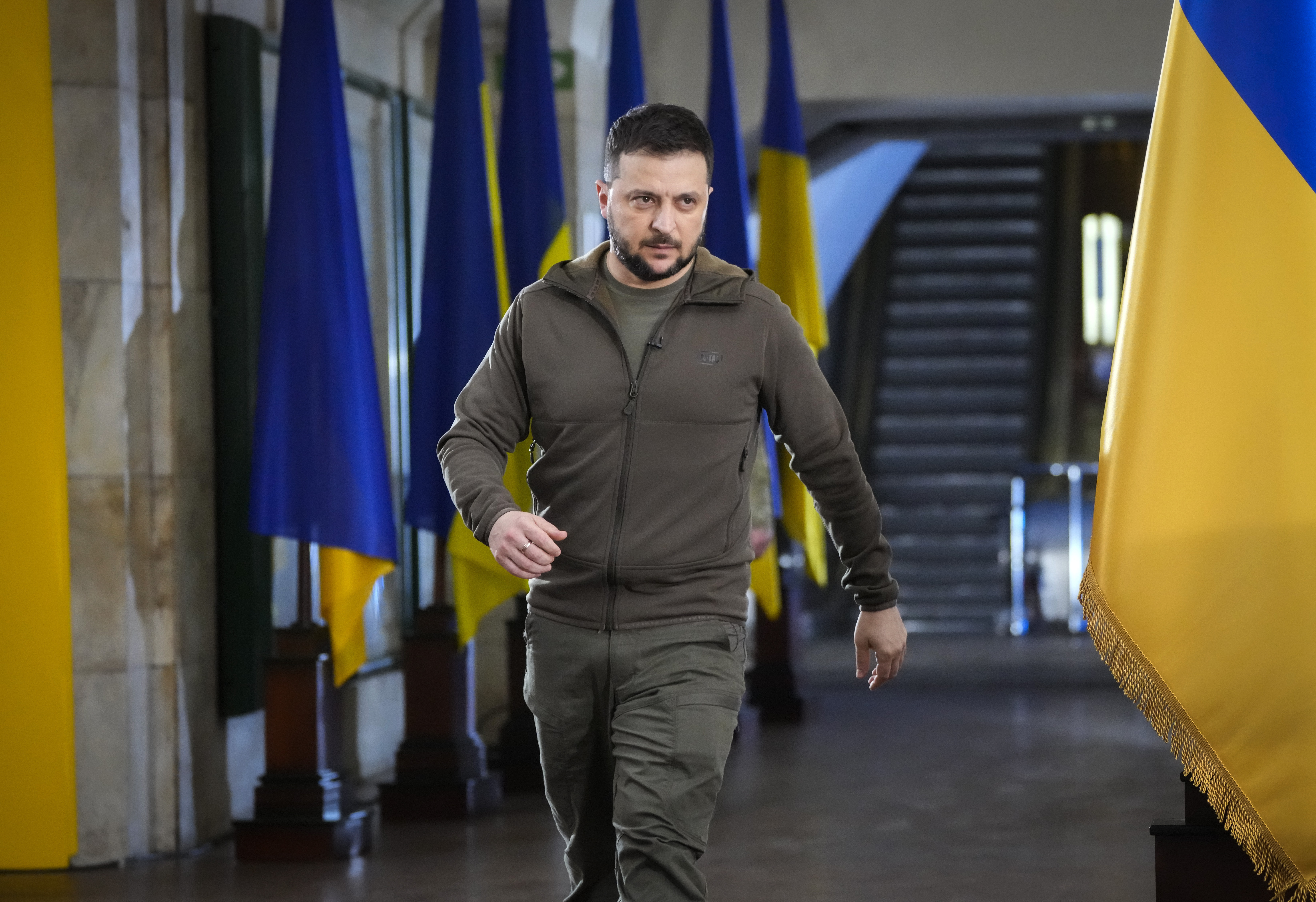 Ukrainian President Volodymyr Zelenskyy walks ahead of a press conference in a city subway under a central square in Kyiv