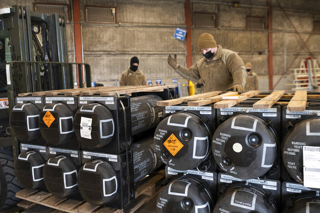 Airmen and civilians from the 436th Aerial Port Squadron palletize ammunition, weapons and other equipment bound for Ukraine during a foreign military sales mission at Dover Air Force Base, Delaware.
