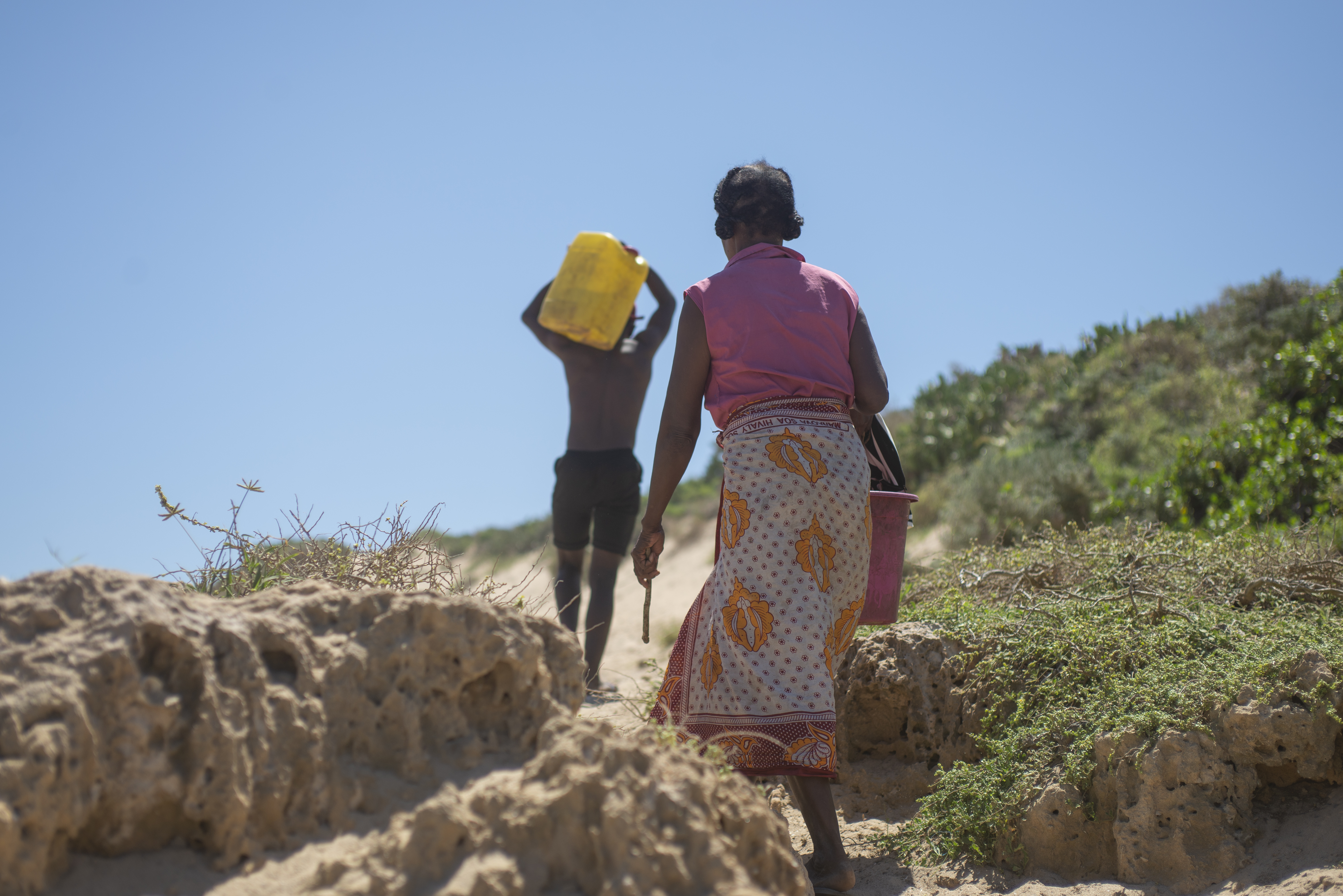 Sija and her grandson said the water from the nearest water point near the village of Ambory in Androy Province is slightly salted and best suited for Zebu, although they drink it when they have no other choice. [Joseph Stepansky/Al Jazeera]