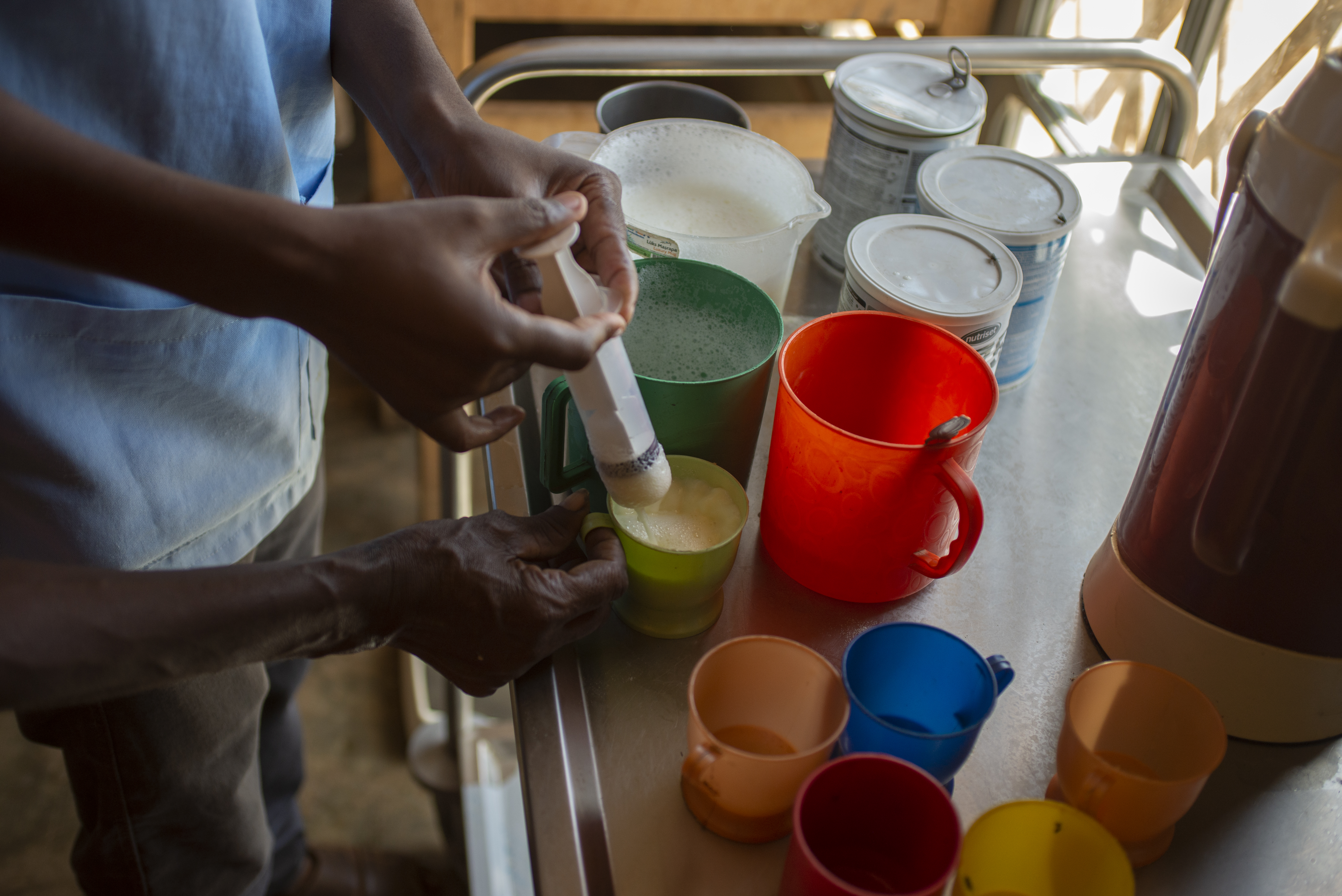 A nurse mixes therapeutic milk at the hospital in Ambovombe. An analysis by the Integrated Food Security Phase Classification (IPC) said a total of 309,000 children are expected to face acute malnutrition in southern Madagascar between November 2021 and August 2022, with a total of 60,000 projected to face severe acute malnutrition. [Joseph Stepansky/Al Jazeera]