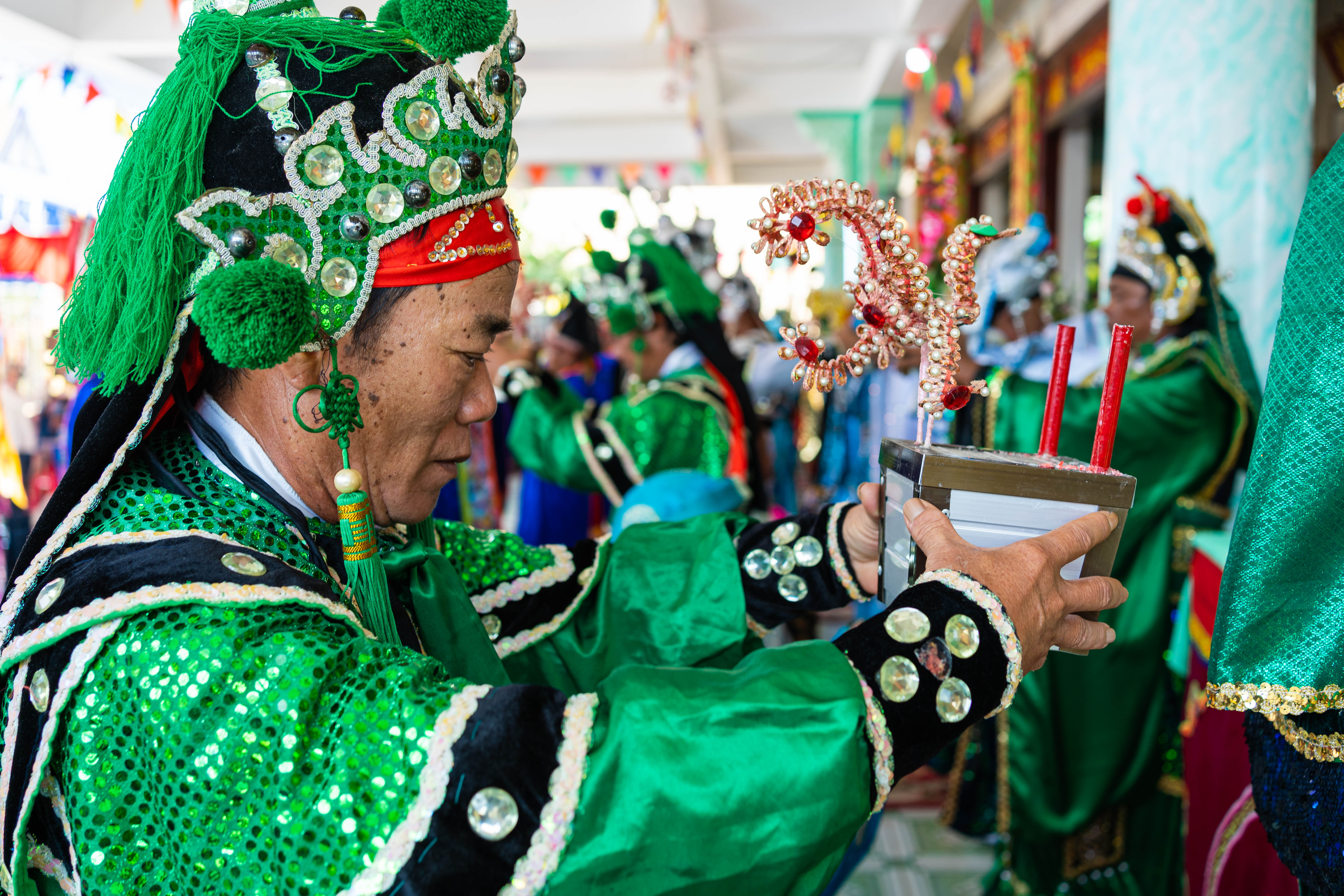 A photo of whale worshippers in elaborate dress carrying candles and flowers as offerings during Phuoc Hai’s whale worship festival.
