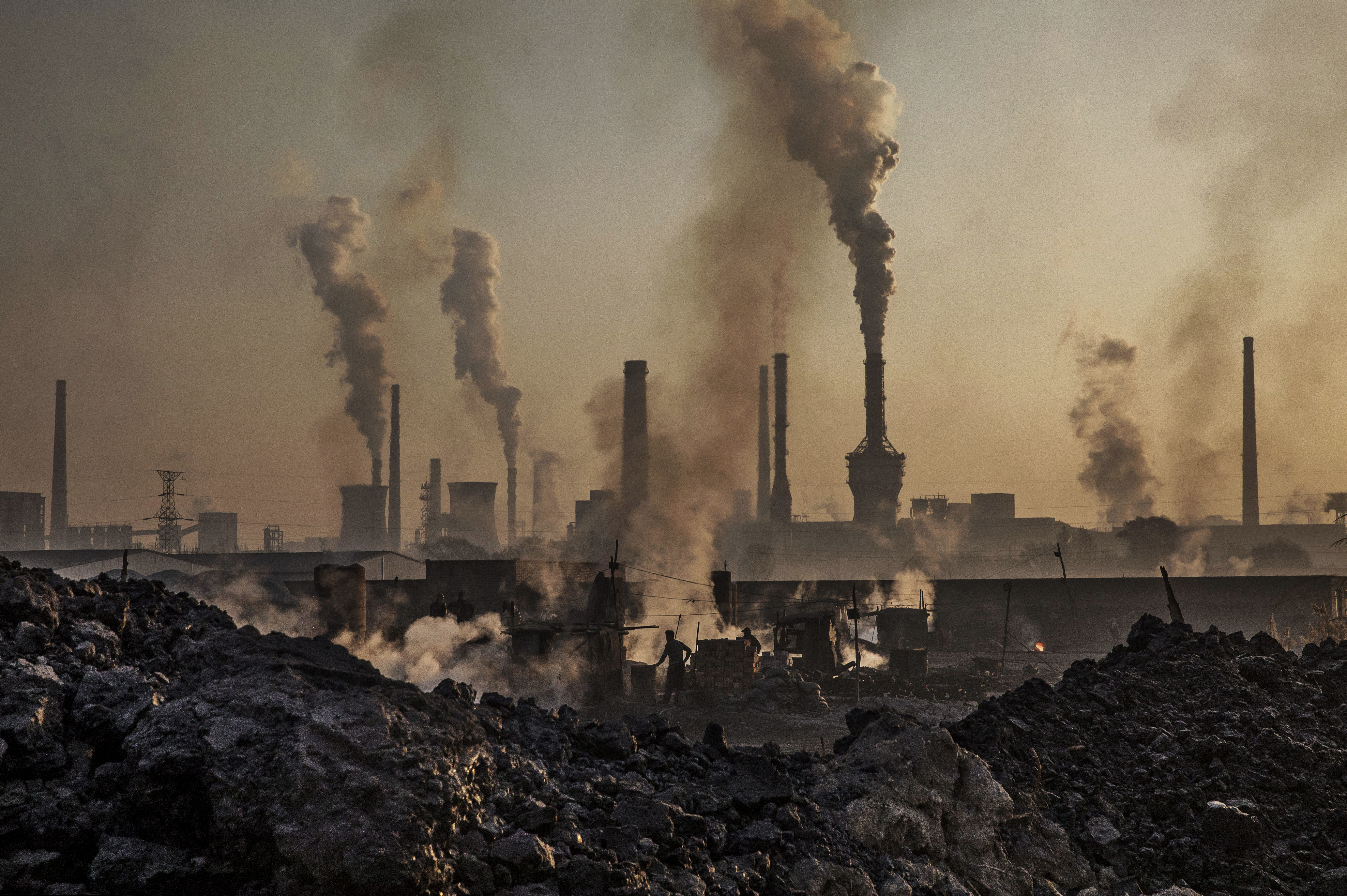 A steel factory is seen in surrounded by smoke