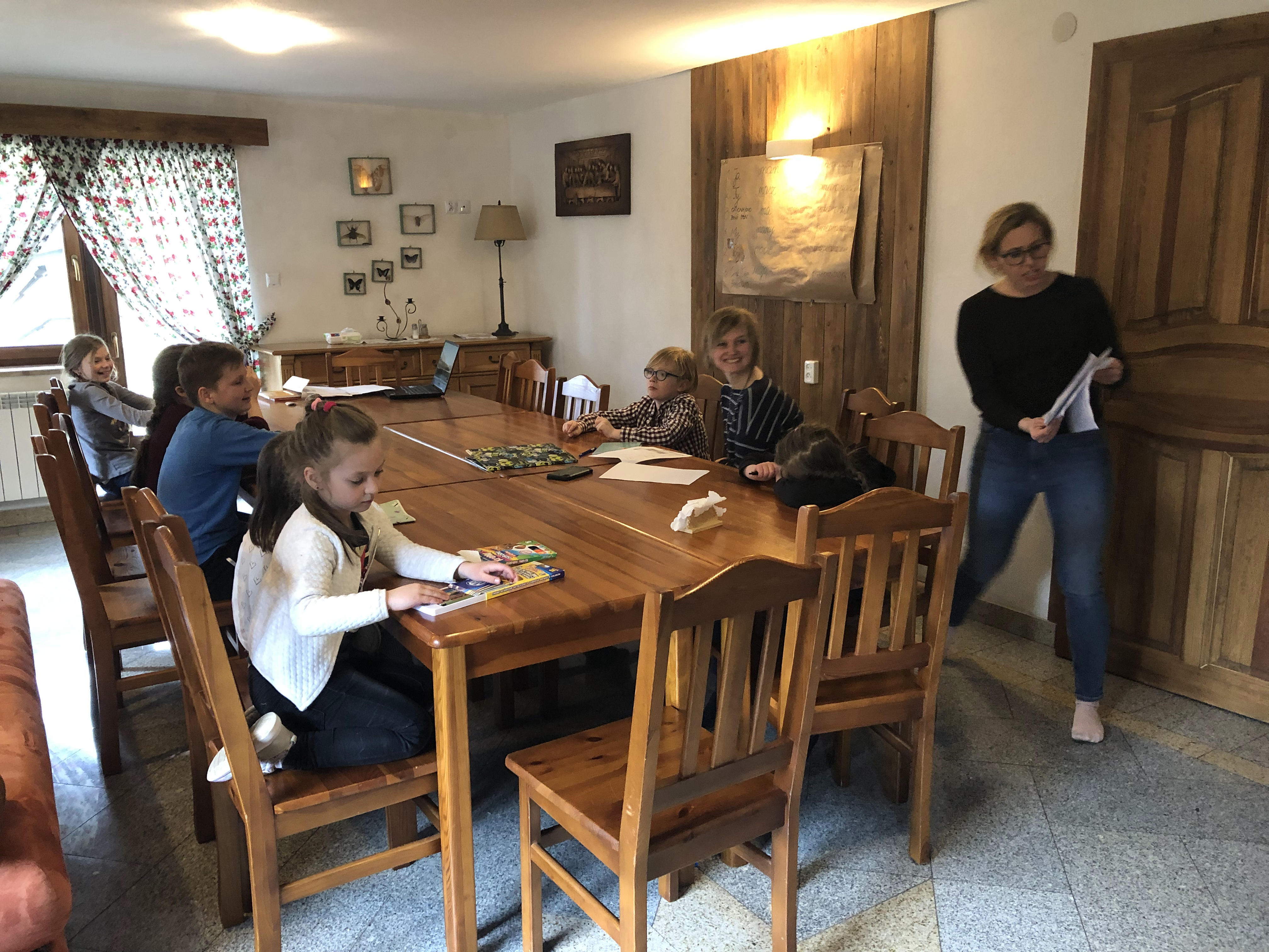 A photo of Jadniga Trebunia distributing Polish worksheets.