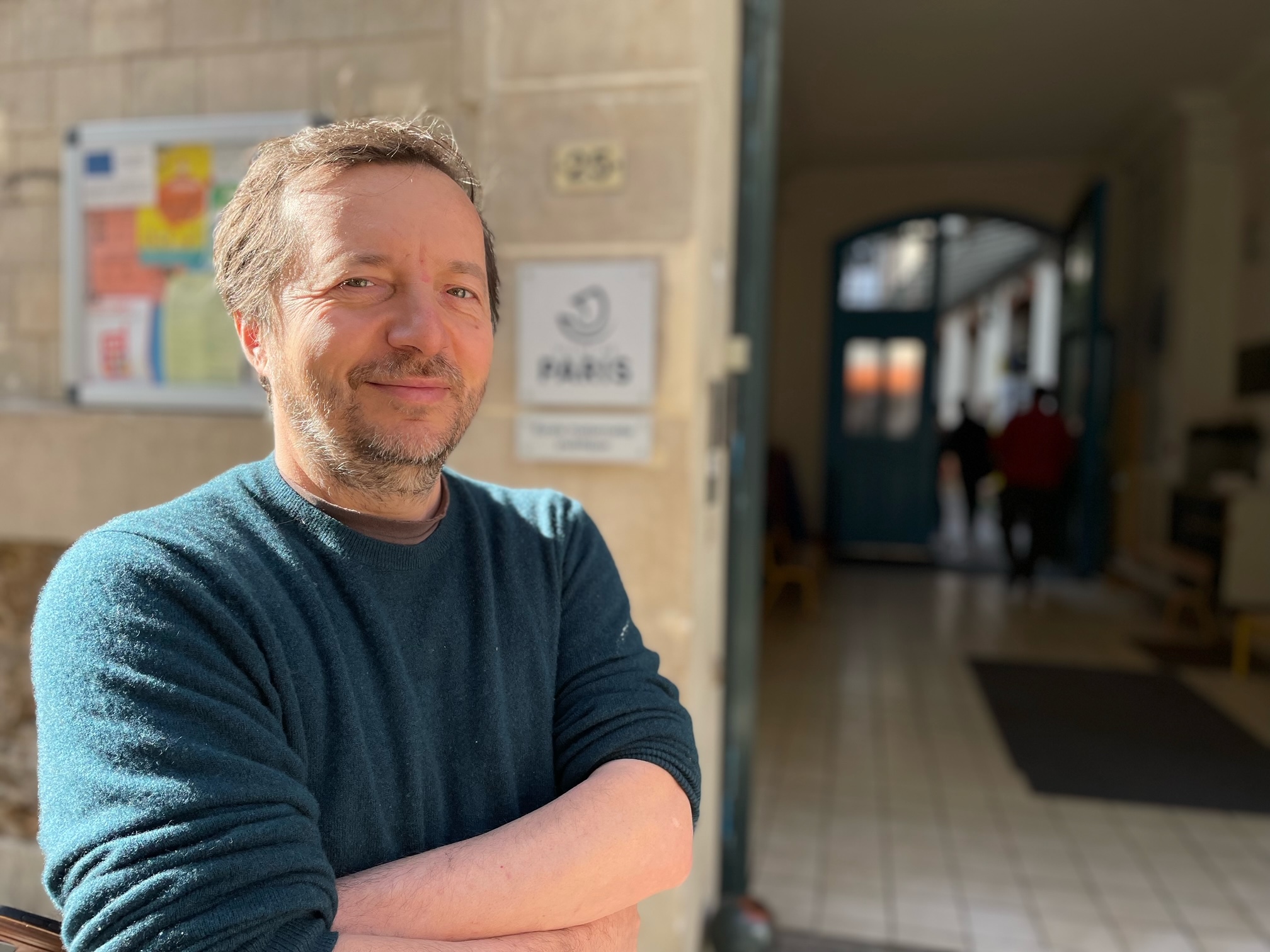 Julien stands in front of a polling station. 