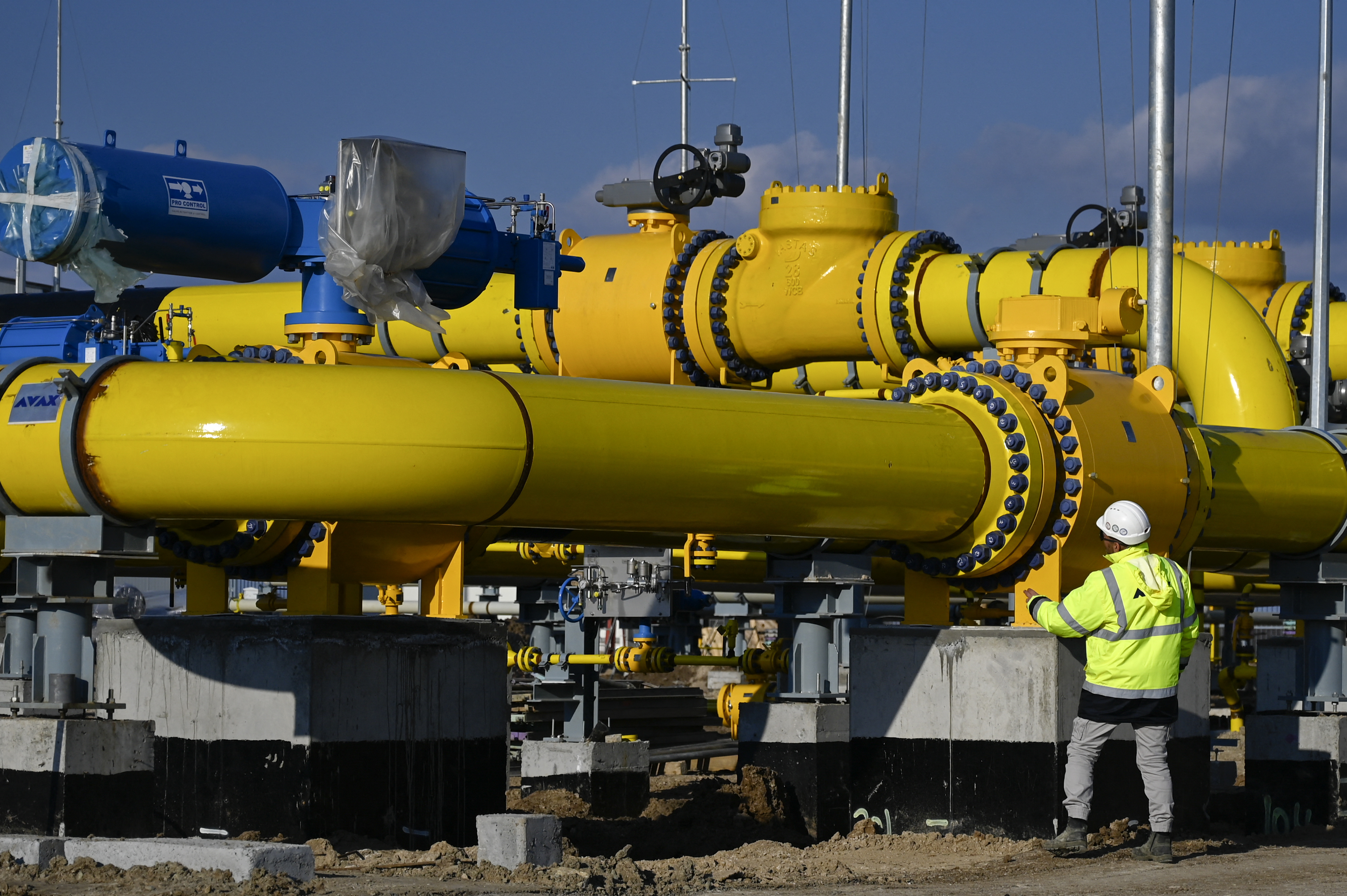 an employee checks a pipe at the construction site of a gas metering station, part of the pipeline link between Bulgaria and Greece near the village of the Malko Kadievo, on March 18, 2022.