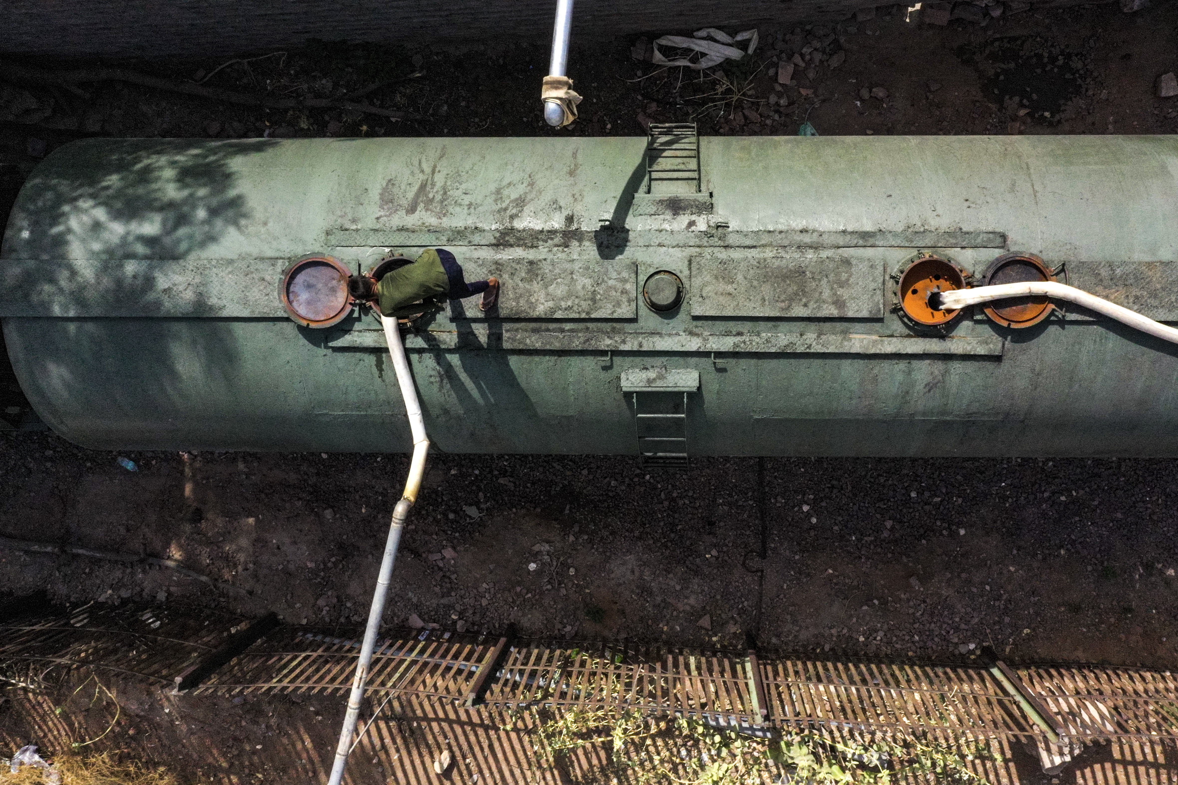 This aerial photograph taken on May 11, 2022 shows a railway employee preparing to refill the water in a tanker of a special train before dispatching for the Pali district on a hot summer day at Bhagat Ki Kothi railway station in Jodhpur