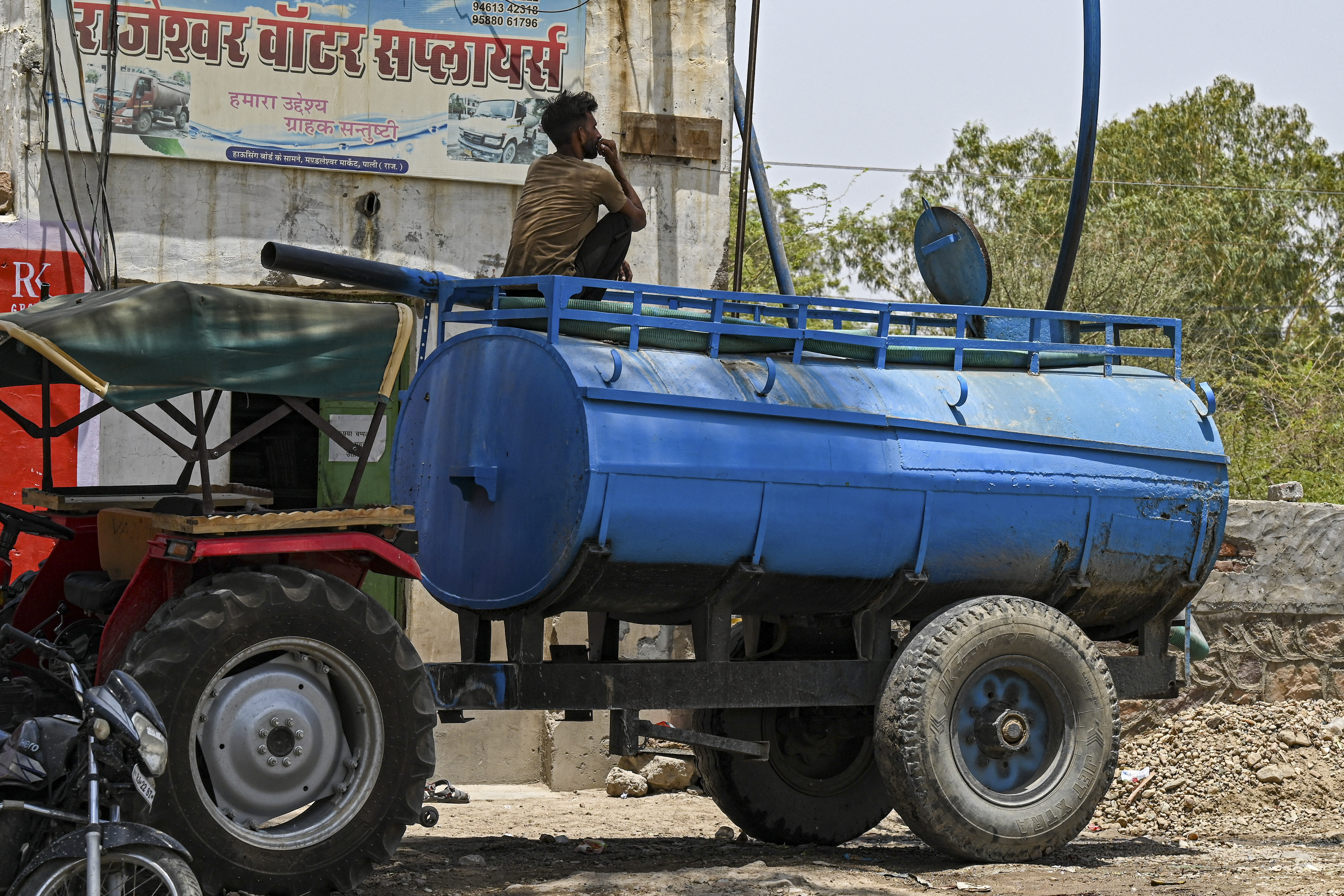 A tanker being refilled with water to supply for the usage by the people on a hot summer day in Pali