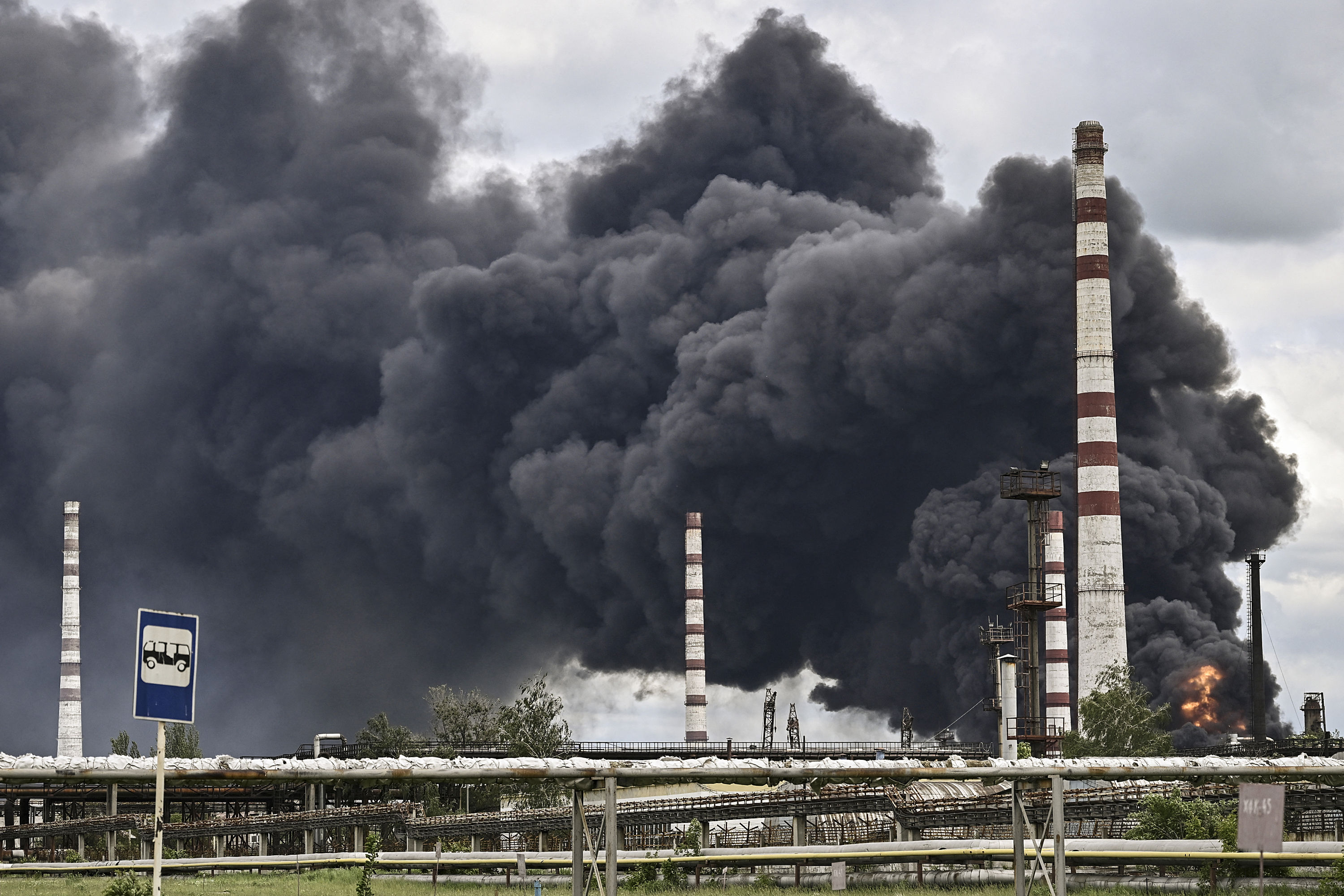 Smoke rises from an oil refinery after an attack outside the city of Lysychansk in the eastern Ukranian region of Donbas