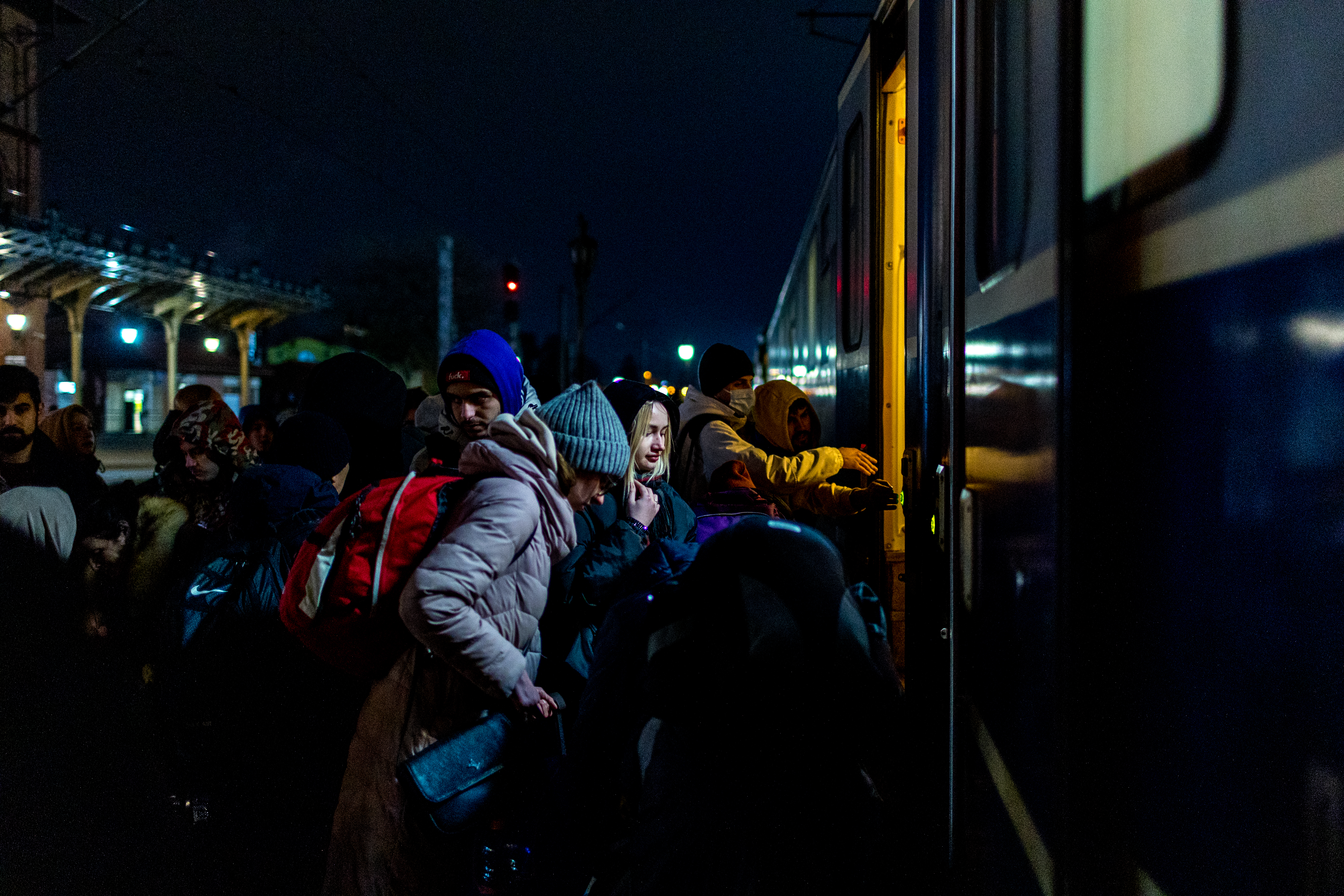 People wait to board a train