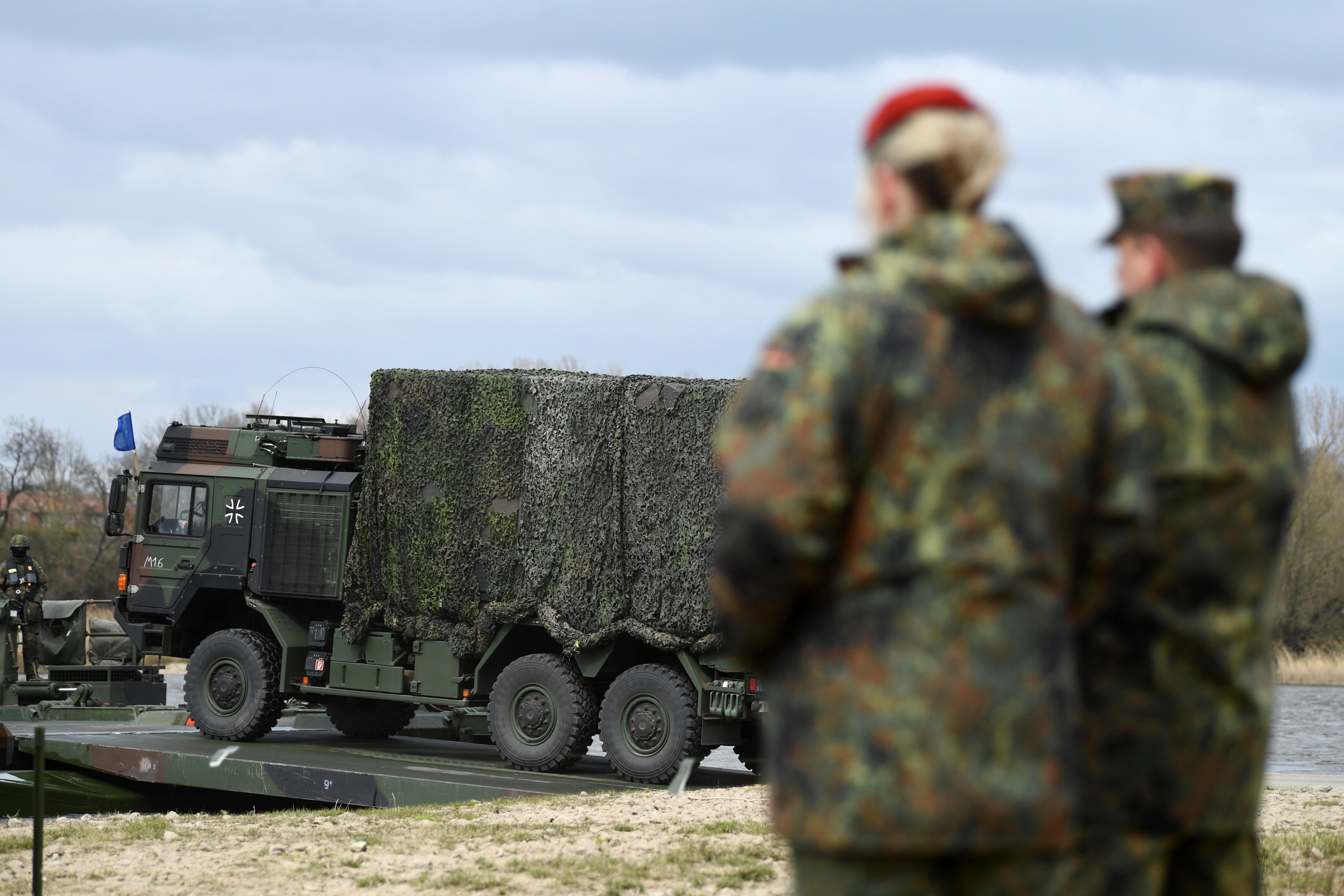 Soldiers of the 37th Panzergrenadier Brigade "Free State of Saxony" of the German Army Bundeswehr board military vehicles meant to be ferried across the Elbe River using the Amphibian M3 floating bridge, during the 'Wettiner Schwert' exercise near Storkau