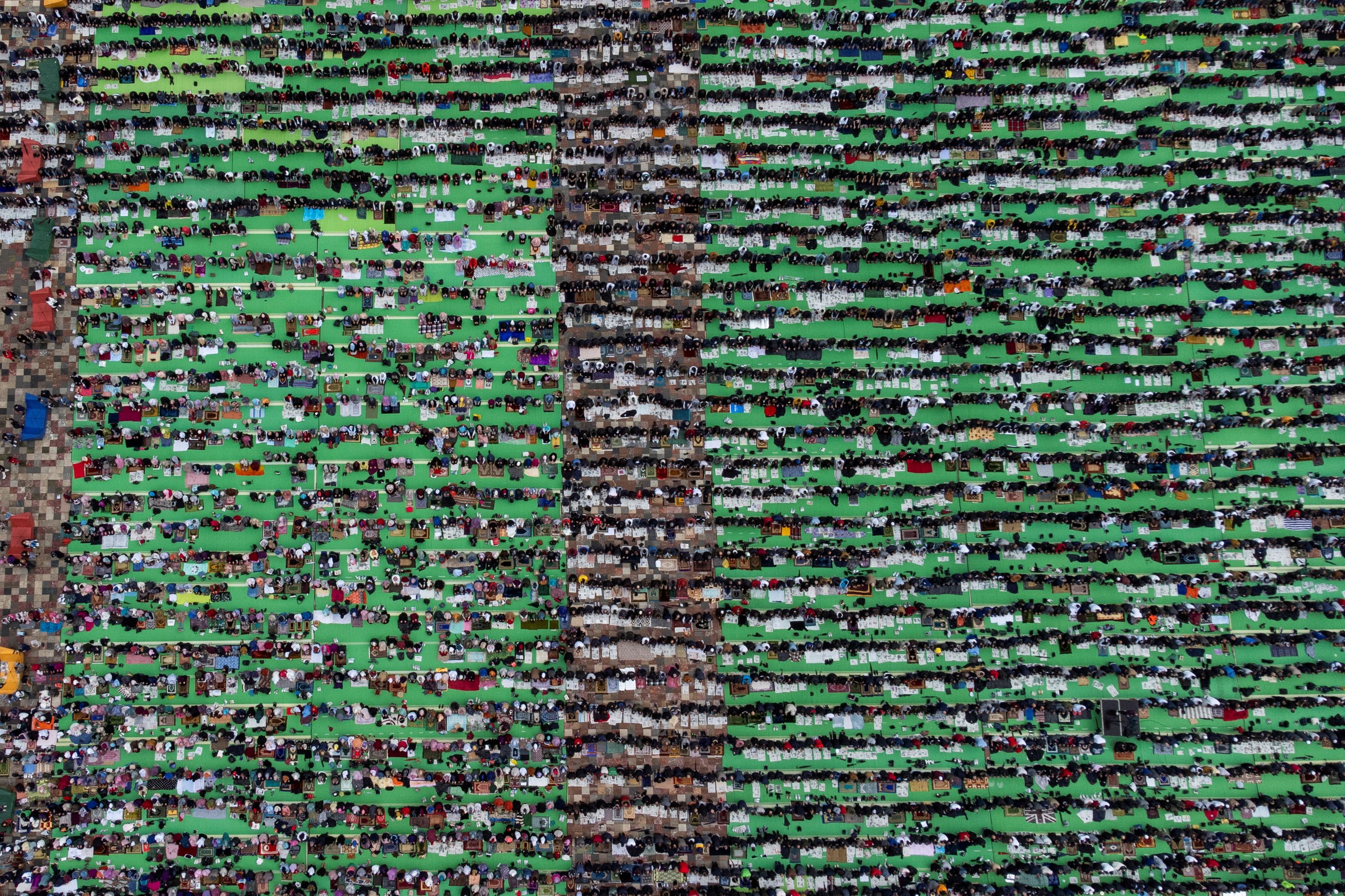 An aerial view shows Albanian Muslims celebrate Eid al-Fitr prayers to mark the end of the holy fasting month of Ramadan, at Skanderbeg Square in Tirana, Albania