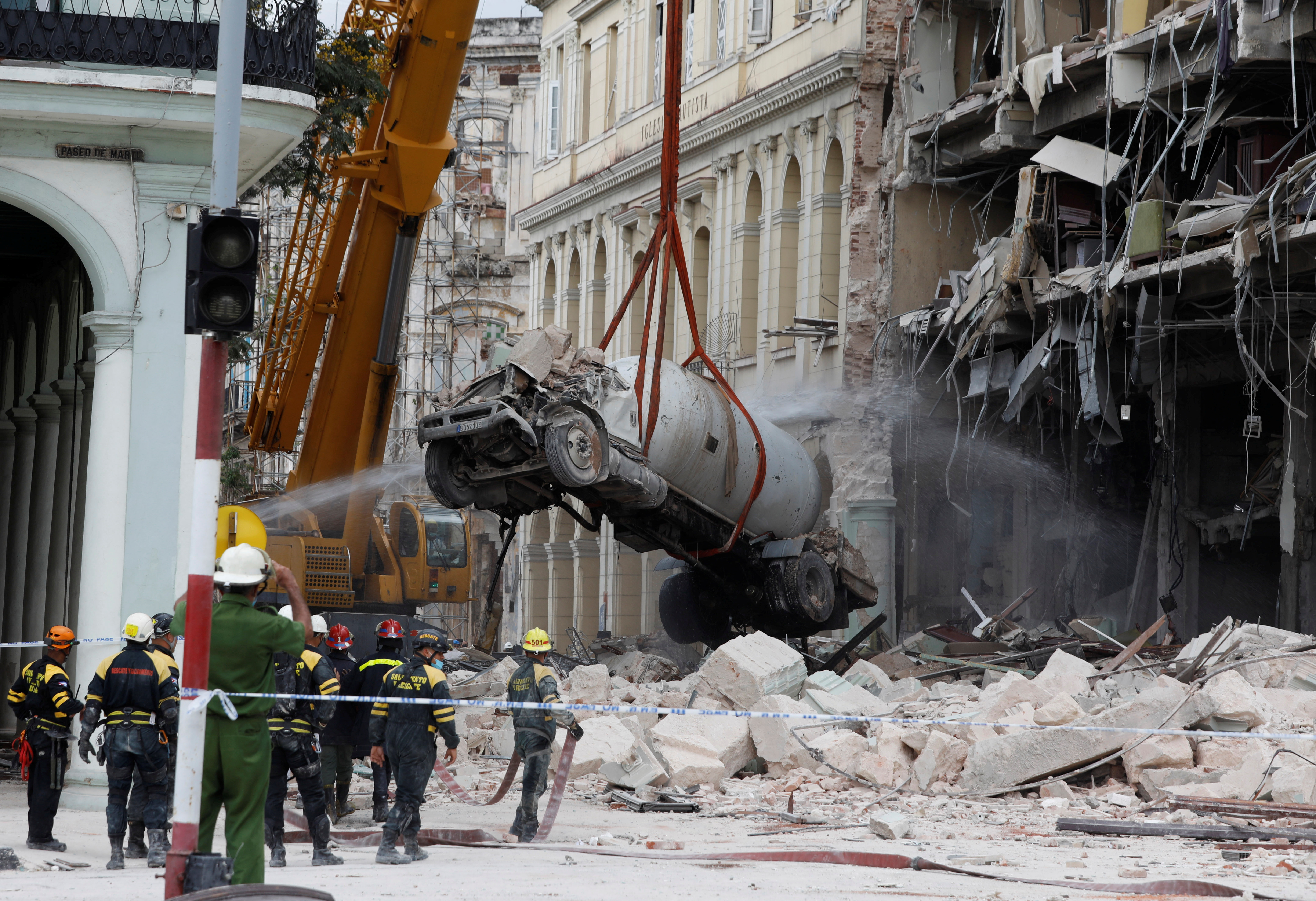 A gas tanker truck is lifted from debris after an explosion hit the Hotel Saratoga, in Havana