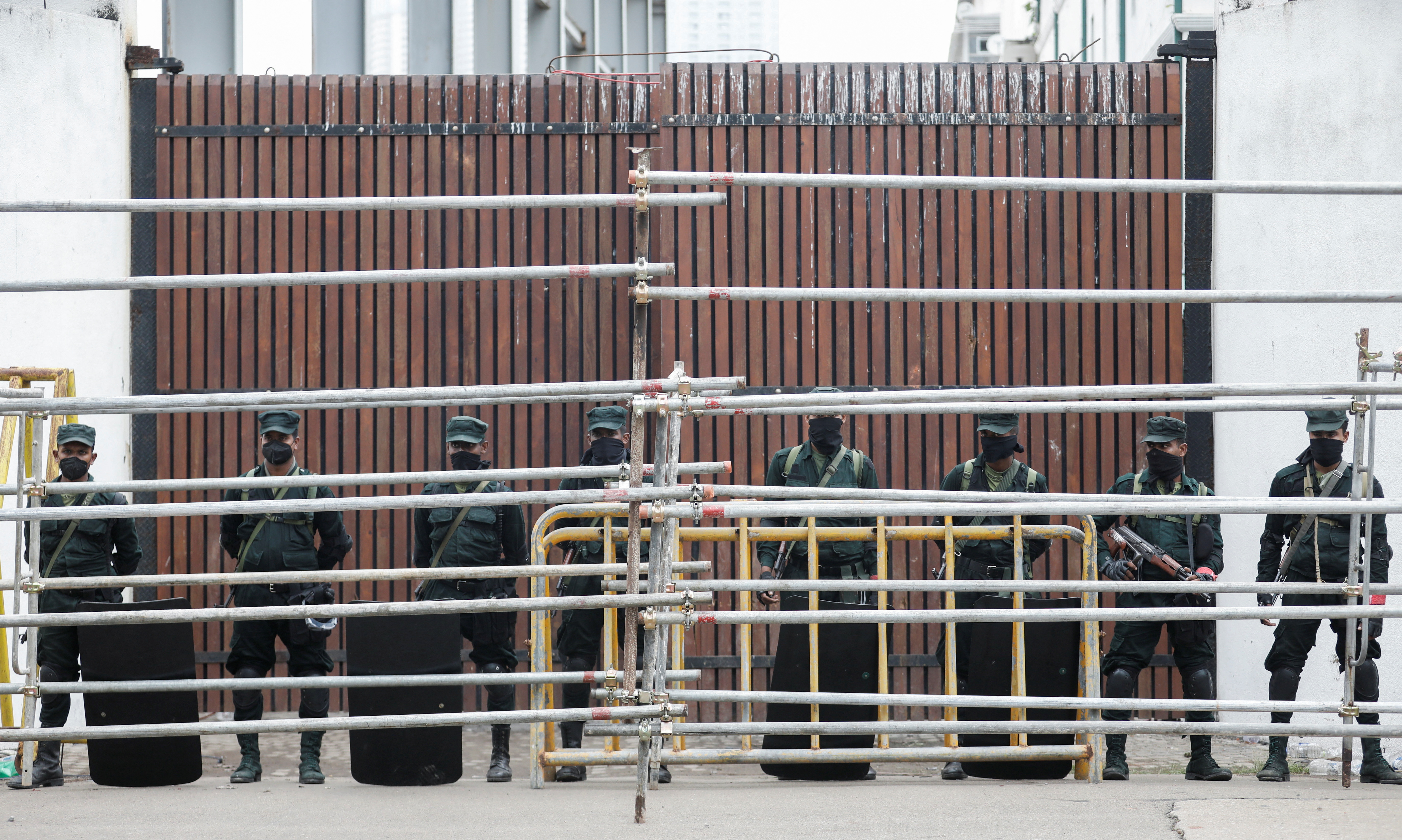 Army soldiers stand guard in front of the Prime Minister's official residence after the government imposed a three-day curfew following clashes between pro and anti-government demonstrators
