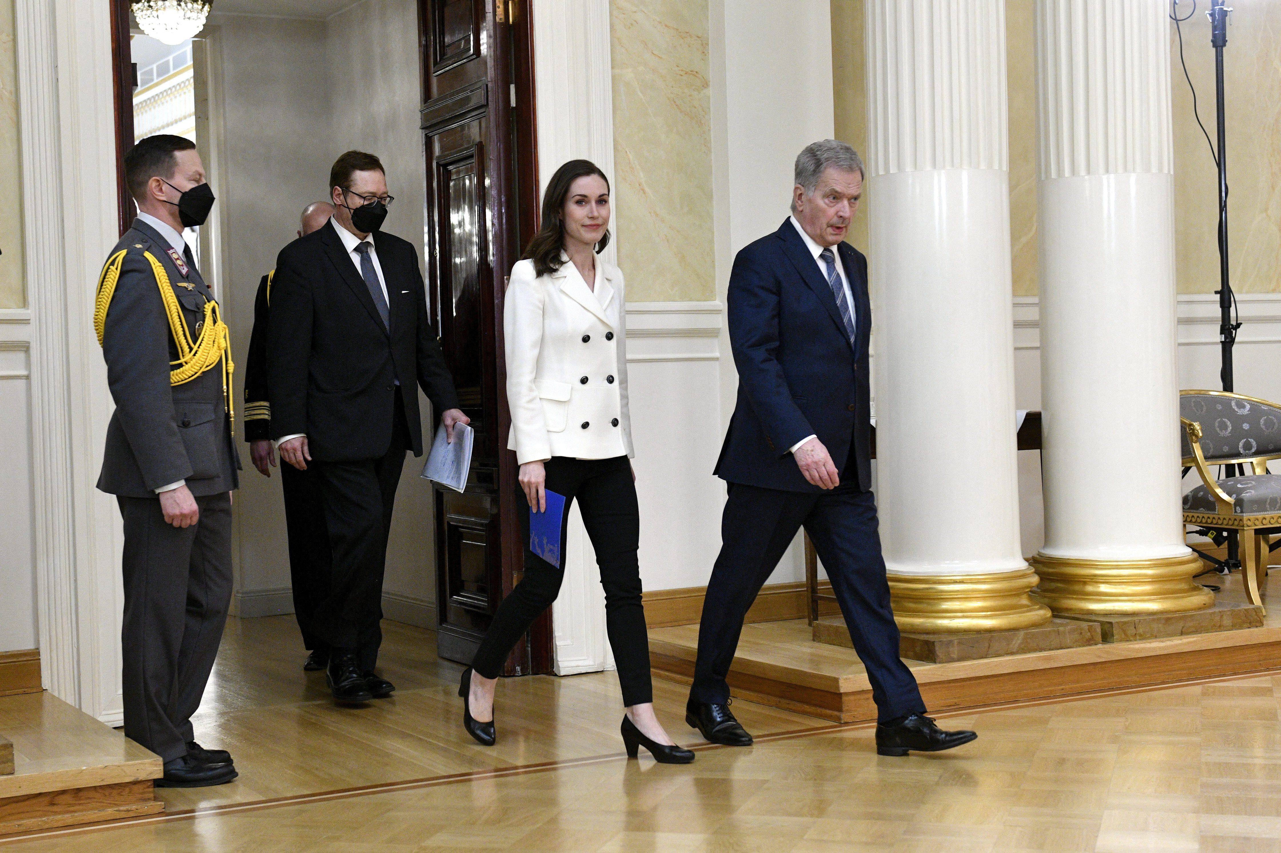 Finland's Prime Minister Sanna Marin (third from left) and Finland's President Sauli Niinisto attend a joint news conference